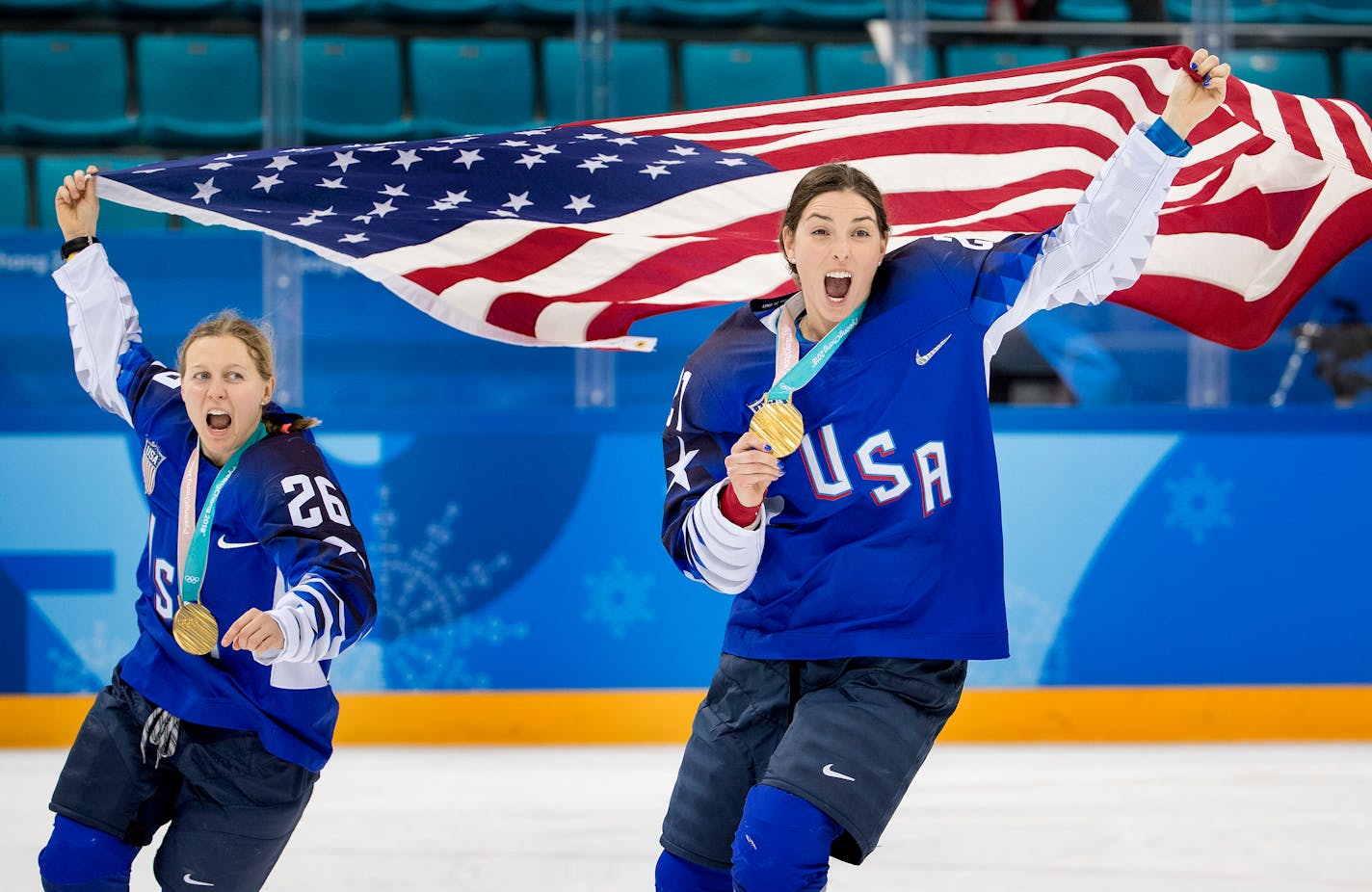 Kendall Coyne (26) and Hilary Knight (21) celebrated after receiving their Olympic gold medals.