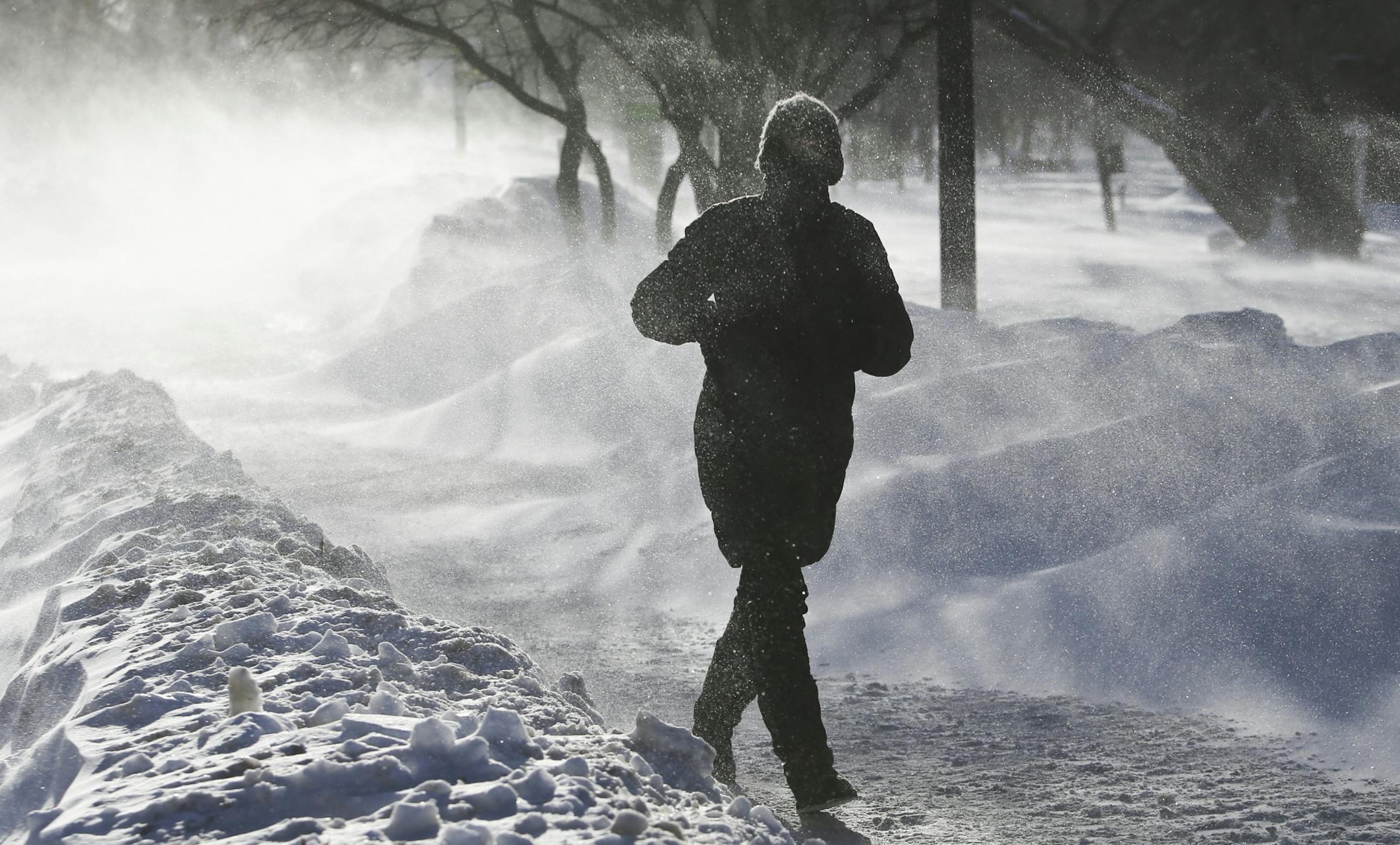 Uve Hamilton of St. Paul was visiting her daughter who lives near Lake Harriet when she decided to tak a walk along the lake in blizzard-like conditions Wednesday Jan. 22, 2014, in Minneapolis, MN. "I don't know how far I'll get," she said. At one point blowing snow was so intense she couldn't see the camera she had brought strapped around her coat and she thought she had dropped it and went back before she realized it was on her.