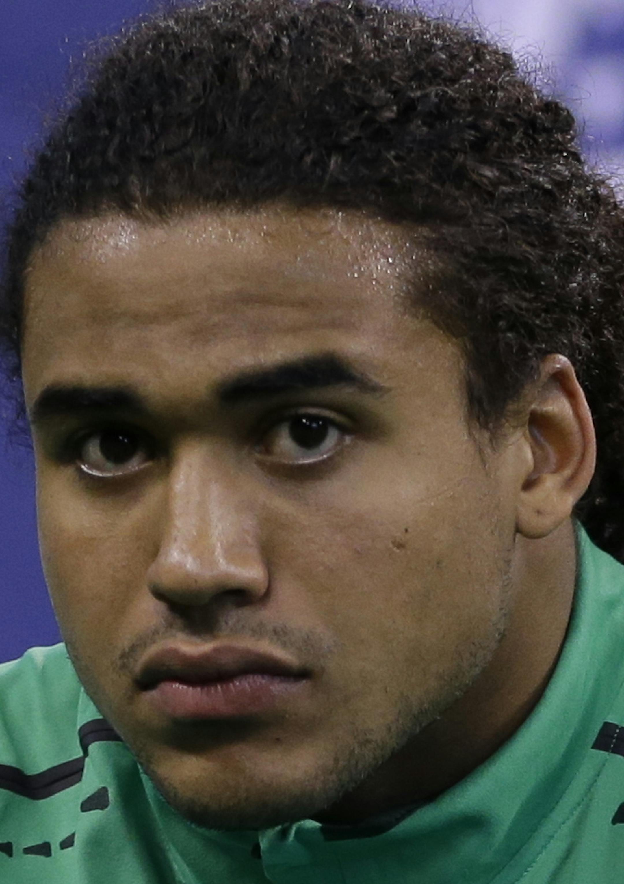 UCLA linebacker Eric Kendricks stretches before drills at the NFL football scouting combine in Indianapolis, Sunday, Feb. 22, 2015. (AP Photo/Julio Cortez) ORG XMIT: INJC13
