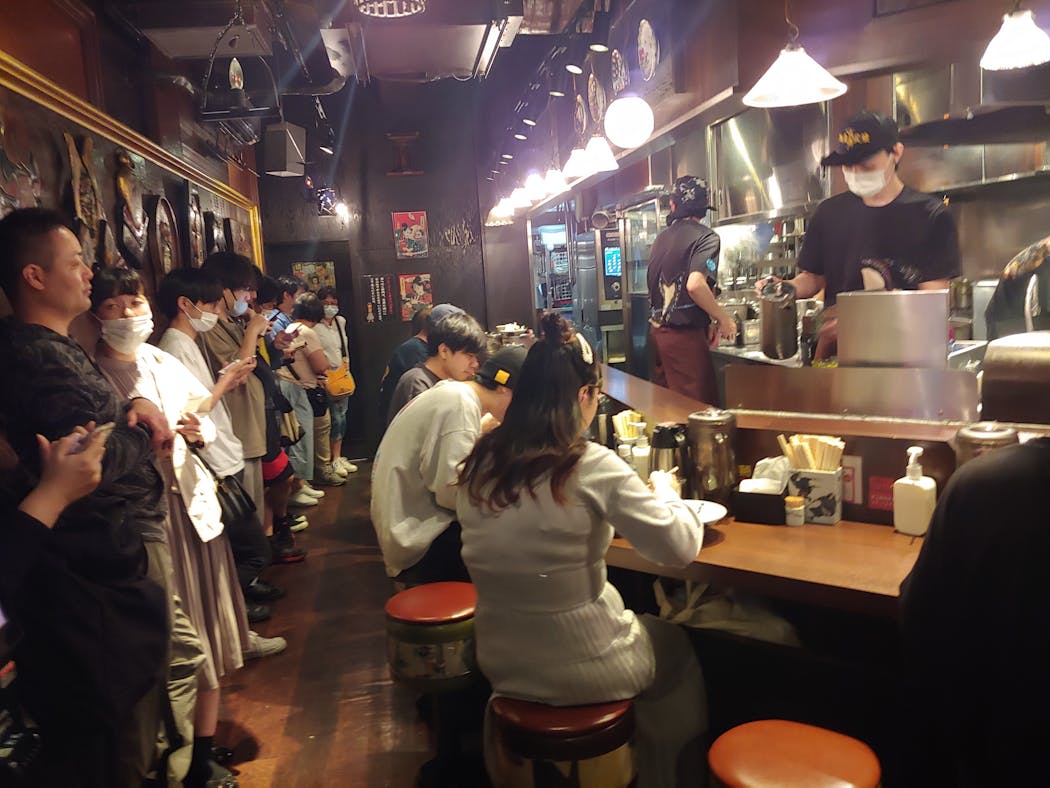 To enjoy the restaurants the locals go to in Japan, like this crowded ramen shop in Tokyo's Shibuya ward, it's wise to bring cash.