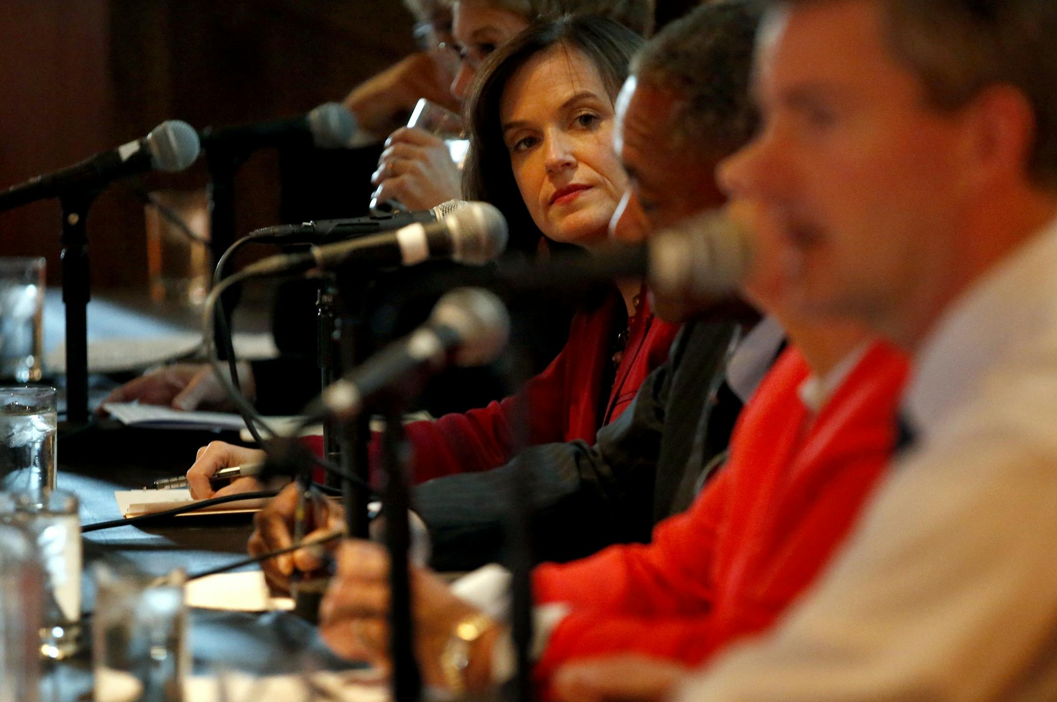 Minneapolis mayoral candidate Betsy Hodges (middle) listened to another candidates' response to a question during a debate at the Mill City Museum on Monday evening.