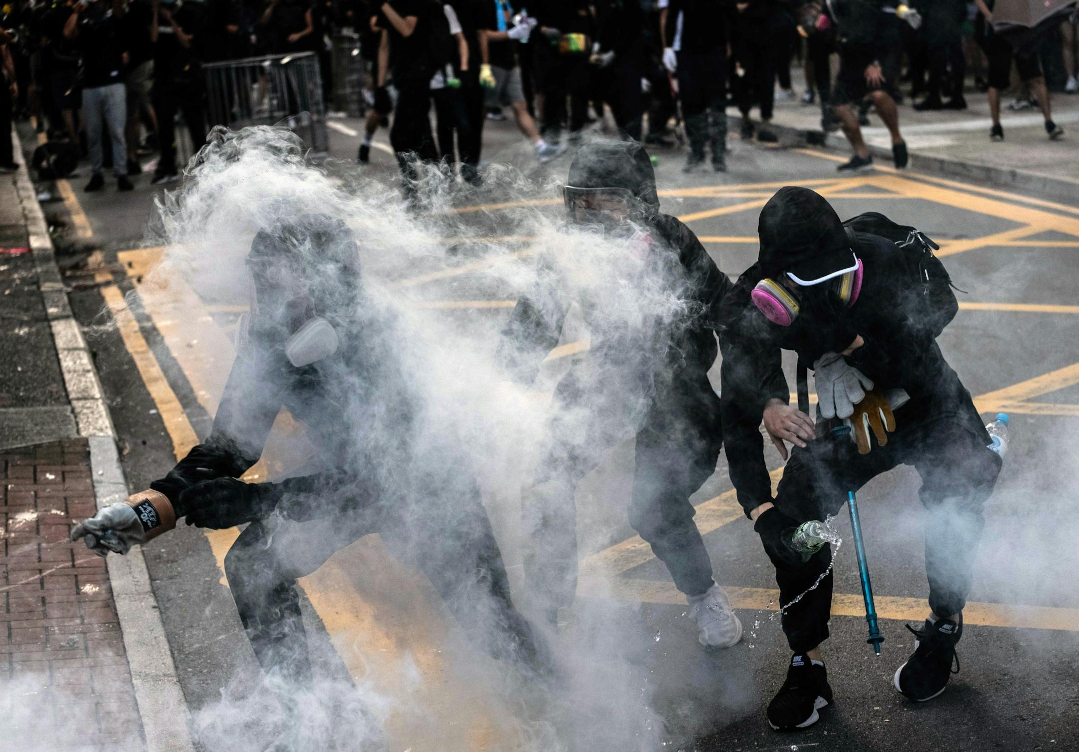 Protesters are engulfed in teargas in Wong Tai Sin, a working-class residential neighborhood in Hong Kong, on Monday, Aug. 5, 2019. Riot police officers fired many volleys of tear gas at protesters in Hong Kong on Monday, as clashes with demonstrators plunged a broad stretch of the territory into chaos. (Lam Yik Fei/The New York Times)