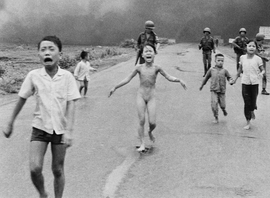 FILE - In this June 8, 1972, file photo, 9-year-old Kim Phuc, center, runs with her brothers and cousins, followed by South Vietnamese forces, down Route 1 near Trang Bang after a South Vietnamese plane accidentally dropped its flaming napalm on its own troops and civilians. The terrified girl had ripped off her burning clothes while fleeing. In late September 2015, Phuc, 52, began a series of laser treatments at the Miami Dermatology and Laser Institute to smooth and soften the pale, thick scar