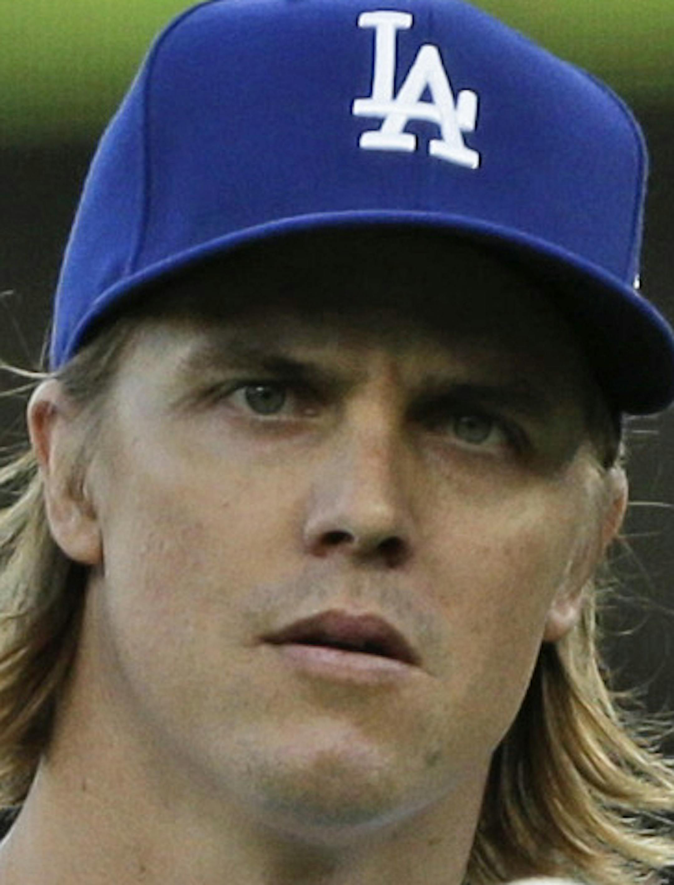 In this Oct. 15, 2015 photo, Los Angeles Dodgers starting pitcher Zack Greinke takes a moment before facing his first New York Mets batter during the first inning in Game 5 of baseball's National League Division Series in Los Angeles. A person with knowledge of the deal tells The Associated Press that free agent Greinke and the Arizona Diamondbacks have reached agreement on a six-year contract. The person spoke to the AP on condition of anonymity Friday night, Dec.4, 2015, because there had not
