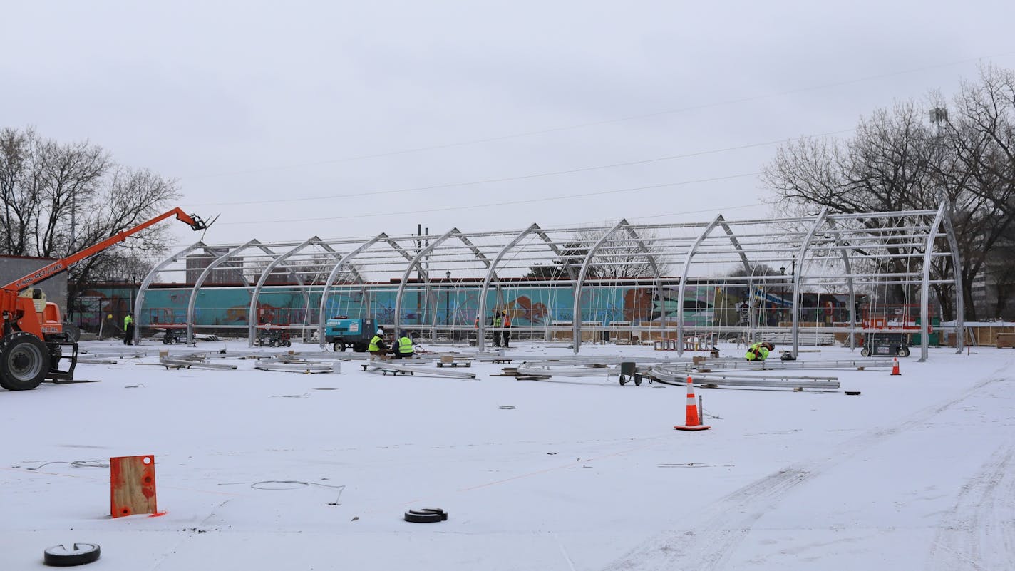 Construction workers erect the metal frame for housing at the site of the new navigation center that will replace the Hiawatha homeless encampment.