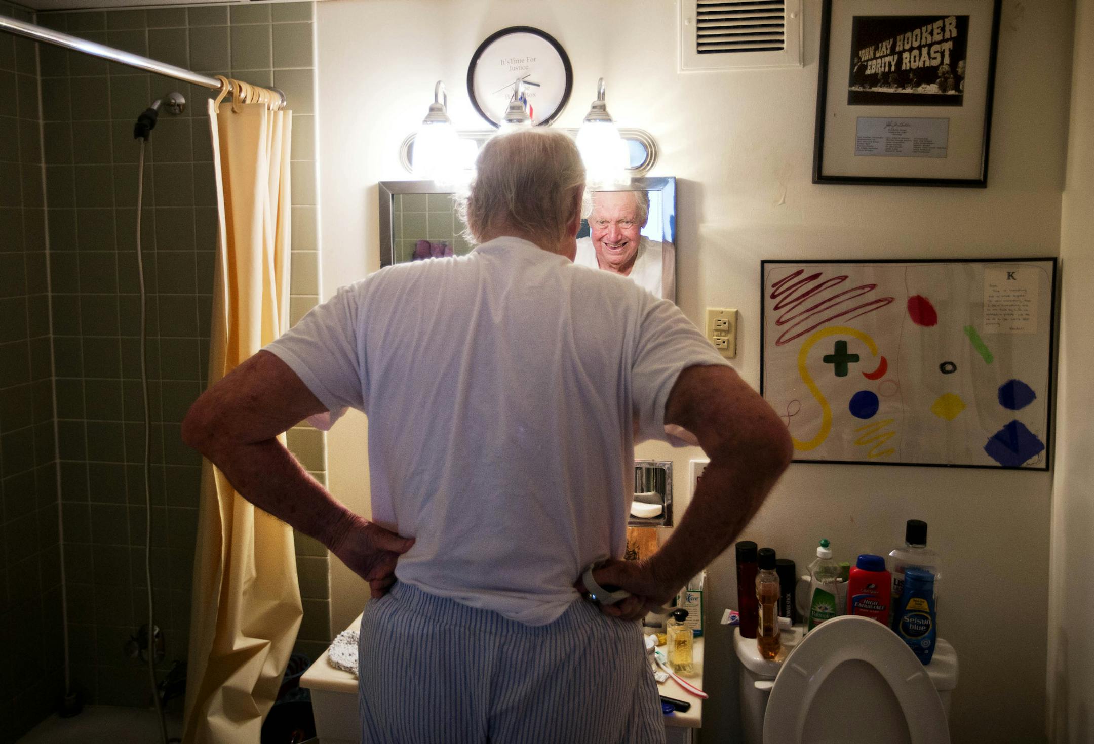 ADVANCE FOR USE MONDAY, NOV. 16 - In this photo taken Aug. 27, 2015, John Jay Hooker stretches in his bathroom as he gets ready for the day before a doctor's appointment in Nashville, Tenn. Being told he was dying breathed new life into the 85-year-old Hooker as he rallied to the cause of physician-assisted suicide. "In a way I feel honored to have this disease," said Hooker. "Most people have something to live for but only a few have something to die for. In a way, I feel like a soldier." (AP P