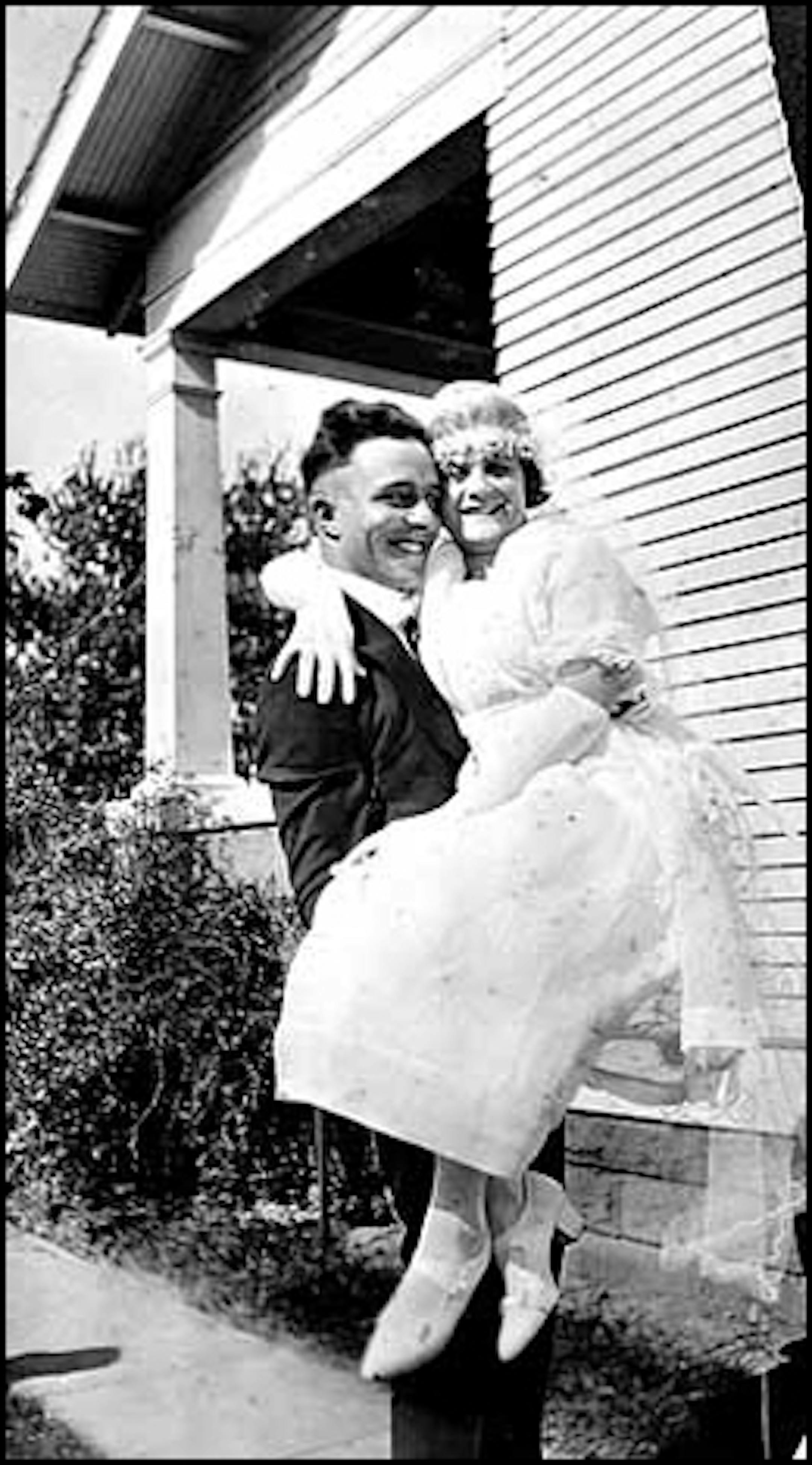 Groom Frank Koch carrying bride Margaret Fischer at 1354 Arcade Street, St. Paul, in about 1920.