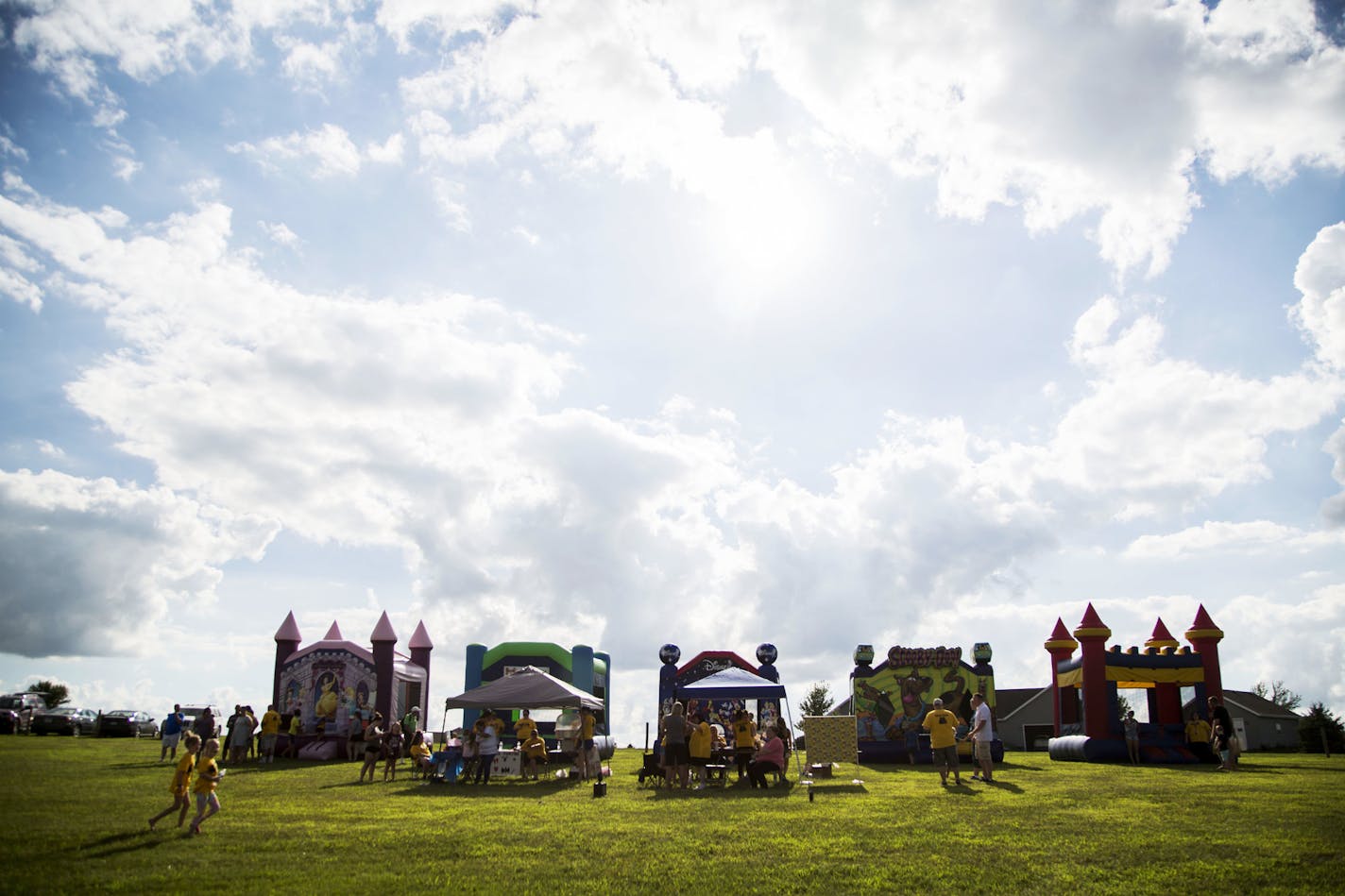 A row of five bouncy houses sat at the top of a hill on the edge of Ryan and Emilie Matthias' front yard in Van Meter, Iowa, during a unique memorial service — just like their 5-year-old son Garrett, who died July 6 of a rare cancer, requested. "I want 5 bouncy houses (because I'm 5), Batman, and snowcones," he said in his obit.