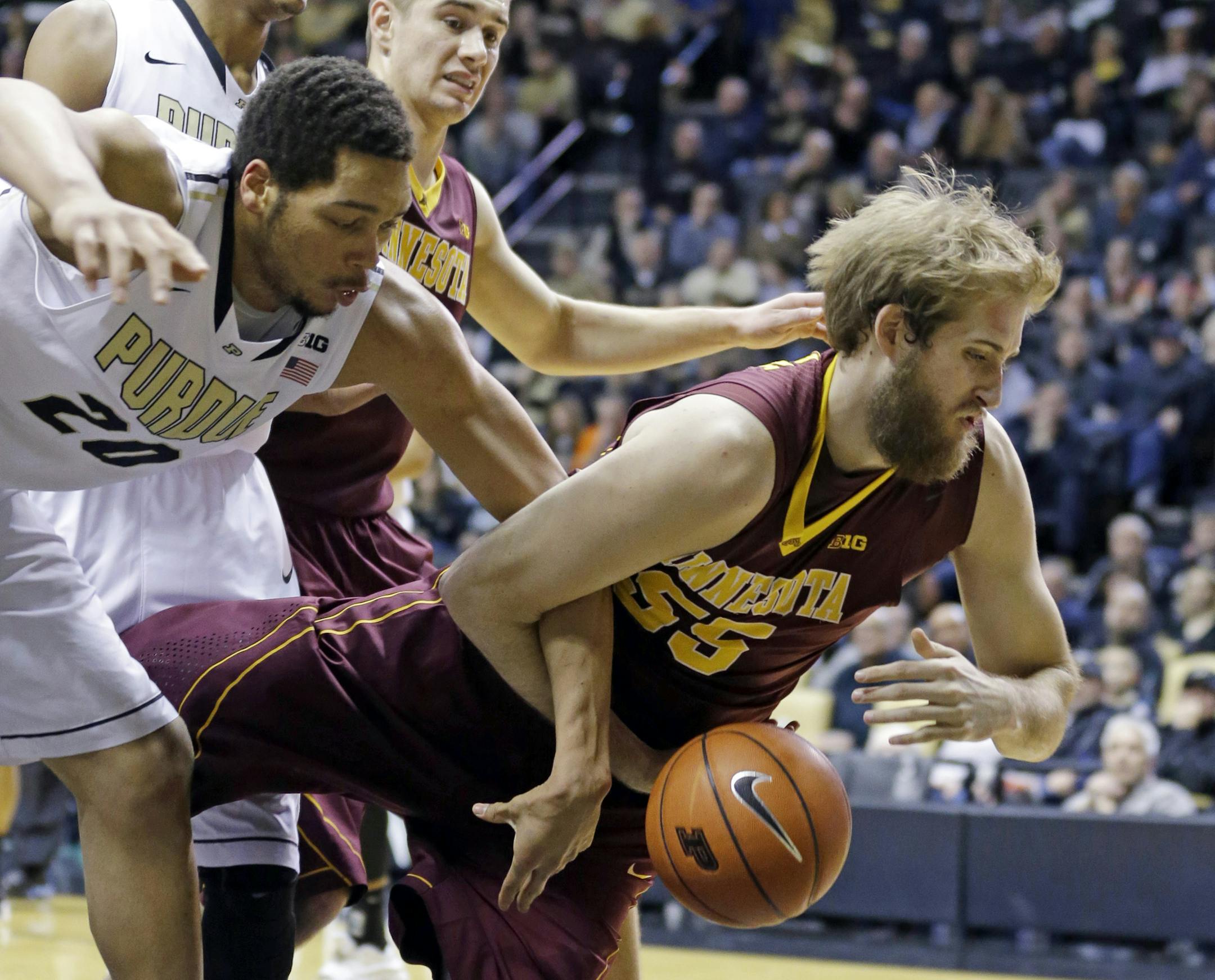 Minnesota center Elliott Eliason (55) and Purdue center A.J. Hammons (20) battle for a loose ball in the second half of an NCAA college basketball game in West Lafayette, Ind., Wednesday, Dec. 31, 2014. Purdue defeated Minnesota 72-68. (AP Photo/Michael Conroy)