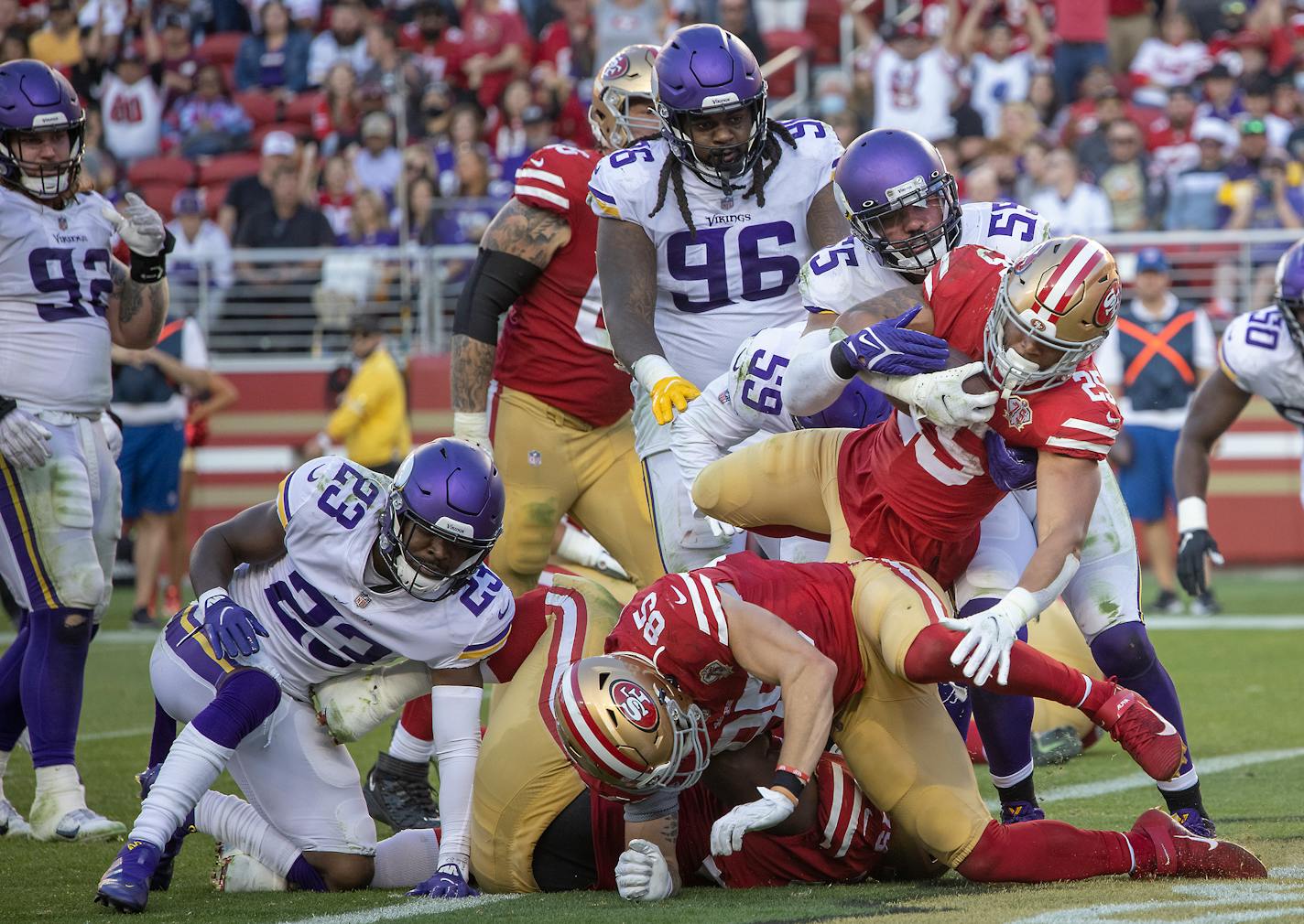 49ers running back Eli Mitchell jumped into the end zone for a touchdown in the third quarter Sunday against the Vikings.