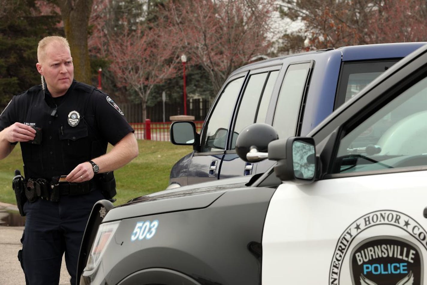 Officer Chris Walswick with the Burnsville Police Department walked back to his patrol vehicle after stopping a driver for texting Wednesday.