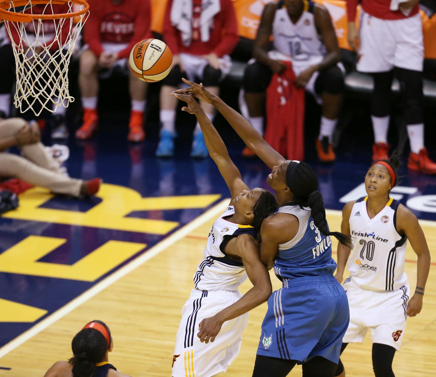 Lynx center Sylvia Fowles (34) fouled Fever forward Tamika Catchings (24) during the second half of Indiana's 75-69 victory in Game 4 of the WNBA Finals on Sunday.