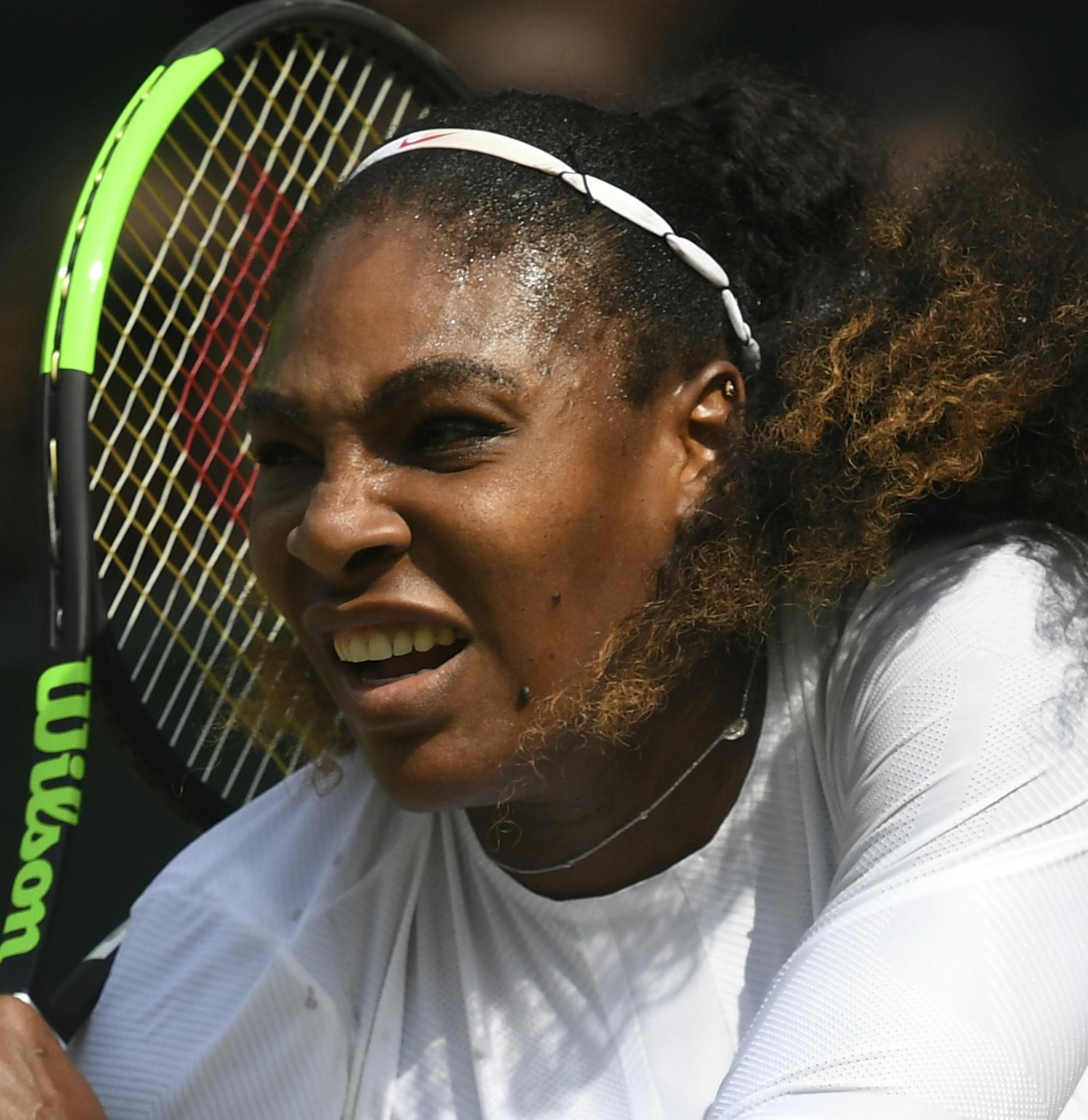 Serena Williams of the US returns a ball to Julia Goerges of Germany during their women's semifinal match at the Wimbledon Tennis Championships in London, Thursday July 12, 2018. (Neil Hall/Pool via AP)