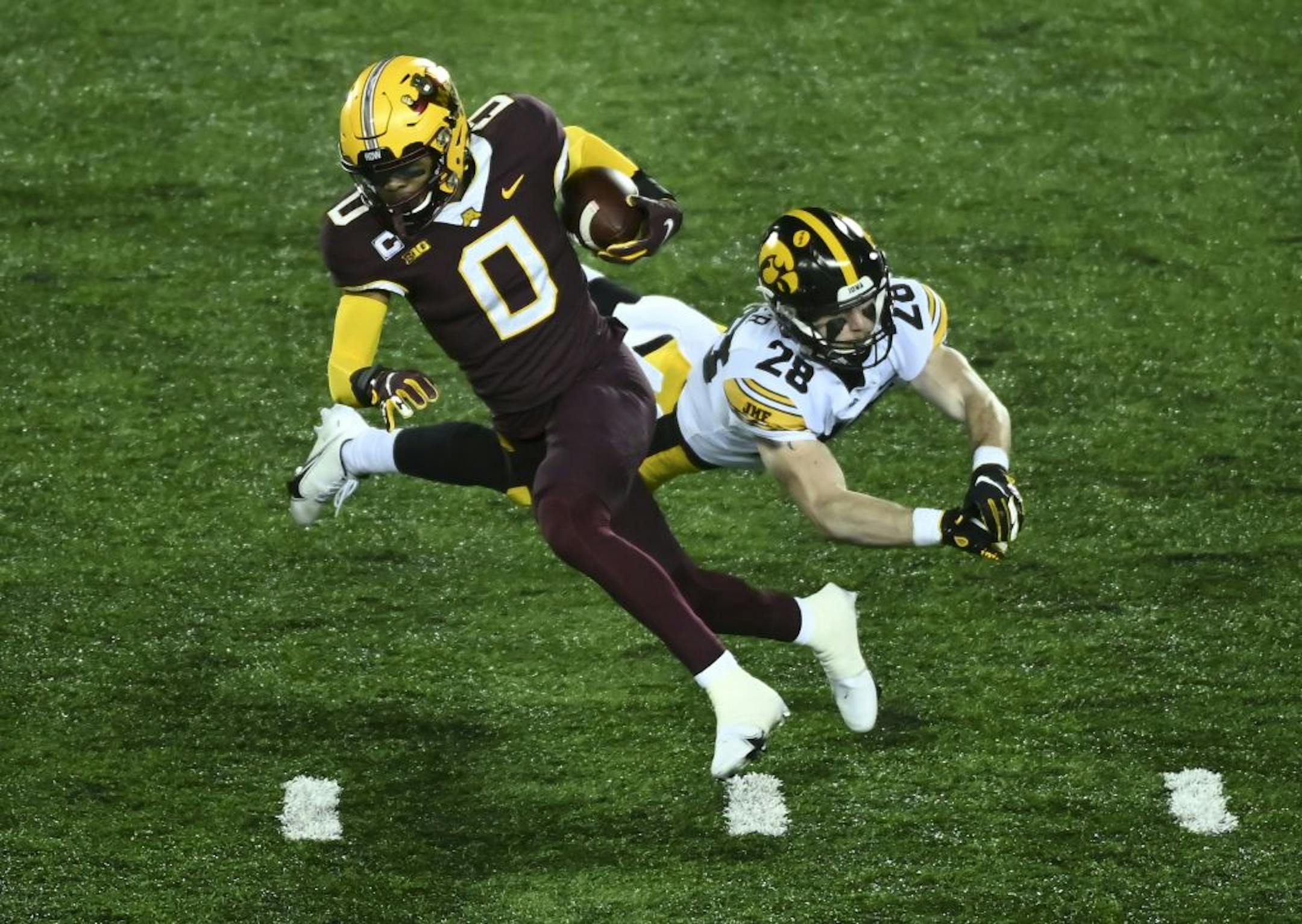 Iowa Hawkeyes defensive back Jack Koerner (28) missed the tackle as Minnesota Gophers wide receiver Rashod Bateman (0) made a first down reception in the third quarter.