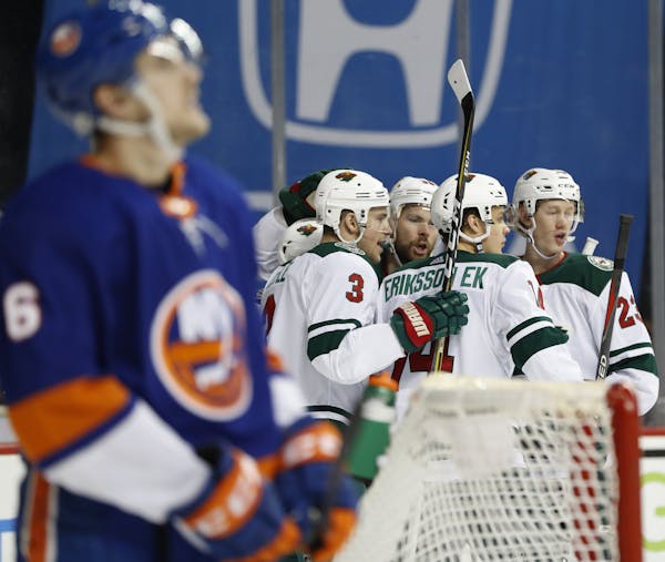 Joel Eriksson Ek (14) celebrated his goal against the Islanders with Wild teammates Monday.