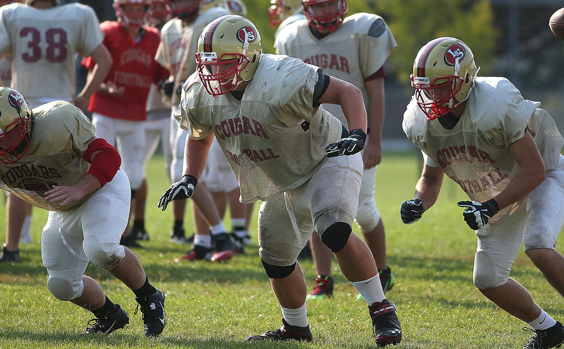 Eric Rousmiller is a center on the Lakeville South team (middle). ] JIM GEHRZ ï james.gehrz@startribune.com / Lakeville, MN / August 26, 2015 / 9:00 AM ñ BACKGROUND INFORMATION: Lakeville South football -- Trying to emerge from Lakeville North's big shadow.
