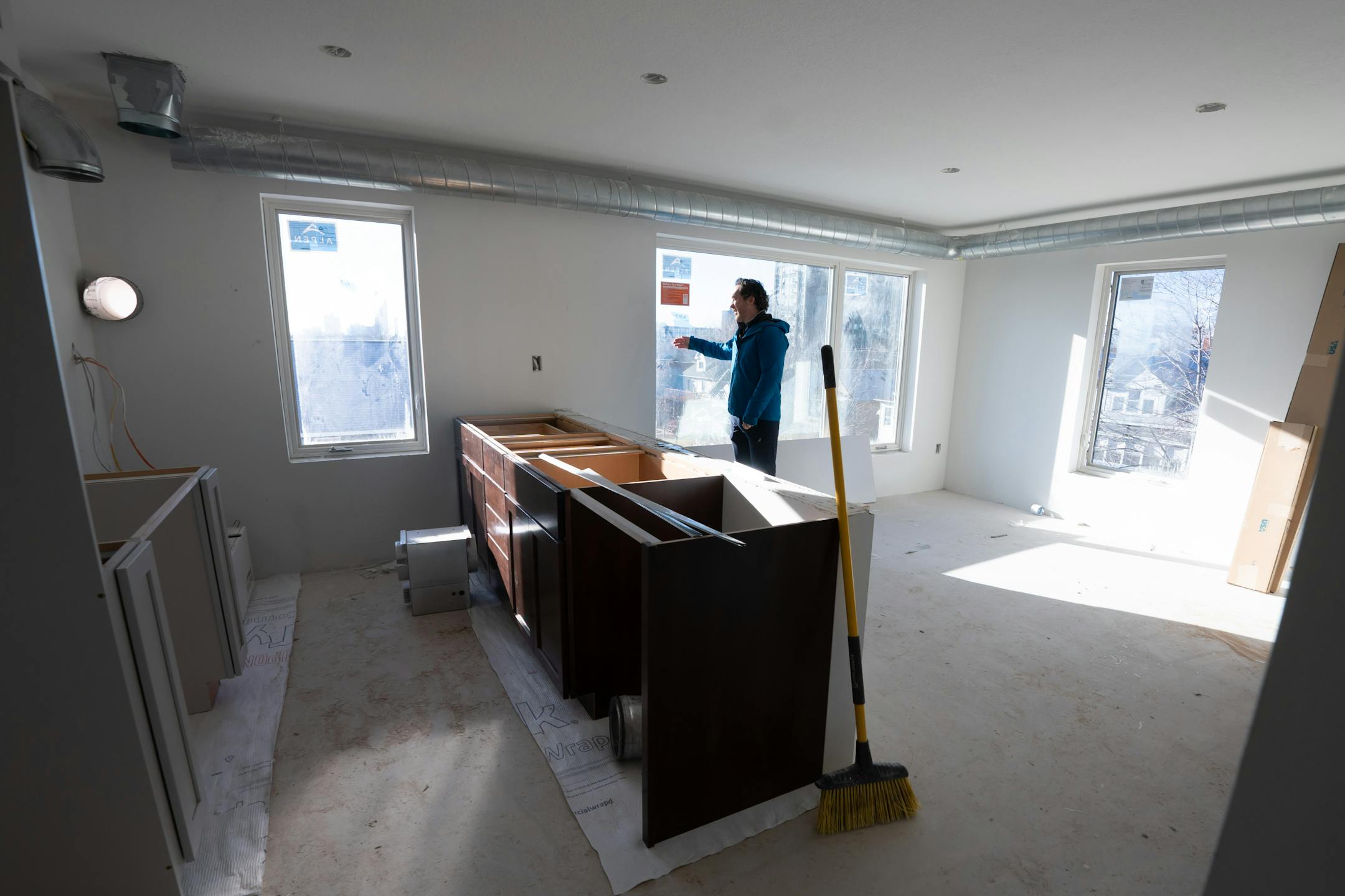 Cody Fischer, who owns Footprint Development, works on getting his project at 635 Van Buren St. NE completed for leasing Friday, Dec. 29, 2023 Minneapolis, Minn. The building has gone through lots of ups and down as a result of the 2040 litigation. It is now almost complete, but another one of Fischer's projects at Minnehaha and 36th is completely stalled. ] GLEN STUBBE • glen.stubbe@startribune.com