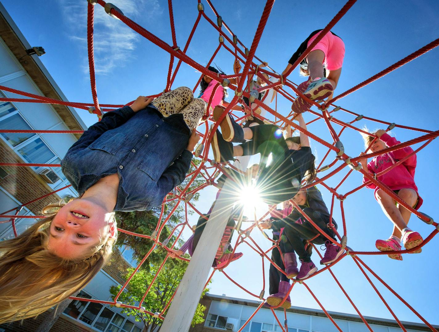 Fifth-grade girls played on a rope jungle gym at Normandale Elementary in Edina. A new form of structured play at recess is being tried out at two elementary schools in Edina.