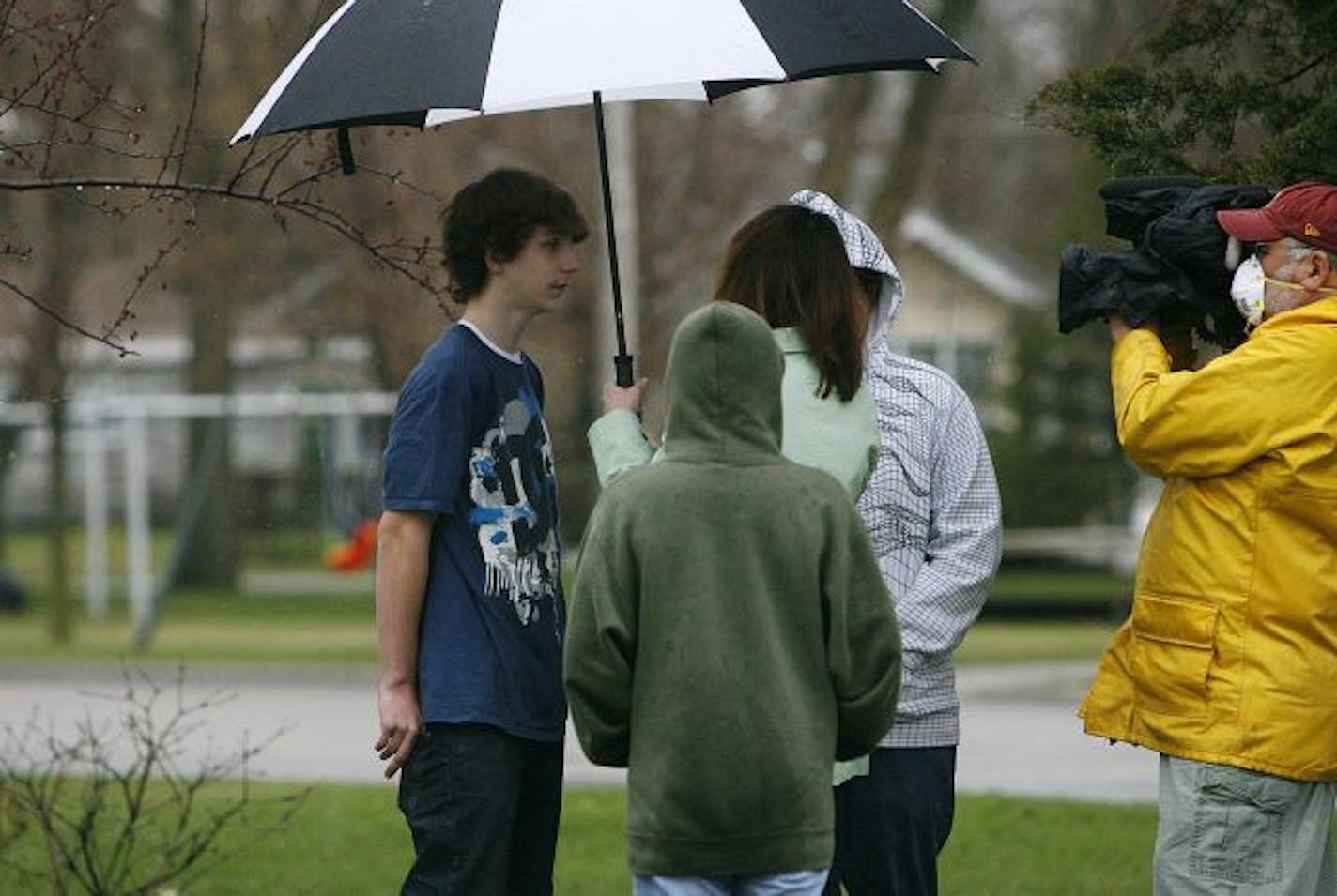 Rocori Middle School student Eli Jahkeenan, left, is interviewed by a media outlet as fellow 8th graders Zavier Gropper, back to camera, and Elijah McClenahan, listen in across the street from Rocori Middle School, which was shut down Wednesday after a student was identified as possibly having contracted the swine flu. The school closing was done as a precautionary measure, officials said, but the strain of flu from the Cold Spring case has not yet been positively identified as the swine flu str