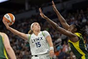 Lynx guard Rachel Banham (15) goes up for two defended by the Storm's Tina Charles during the third quarter.