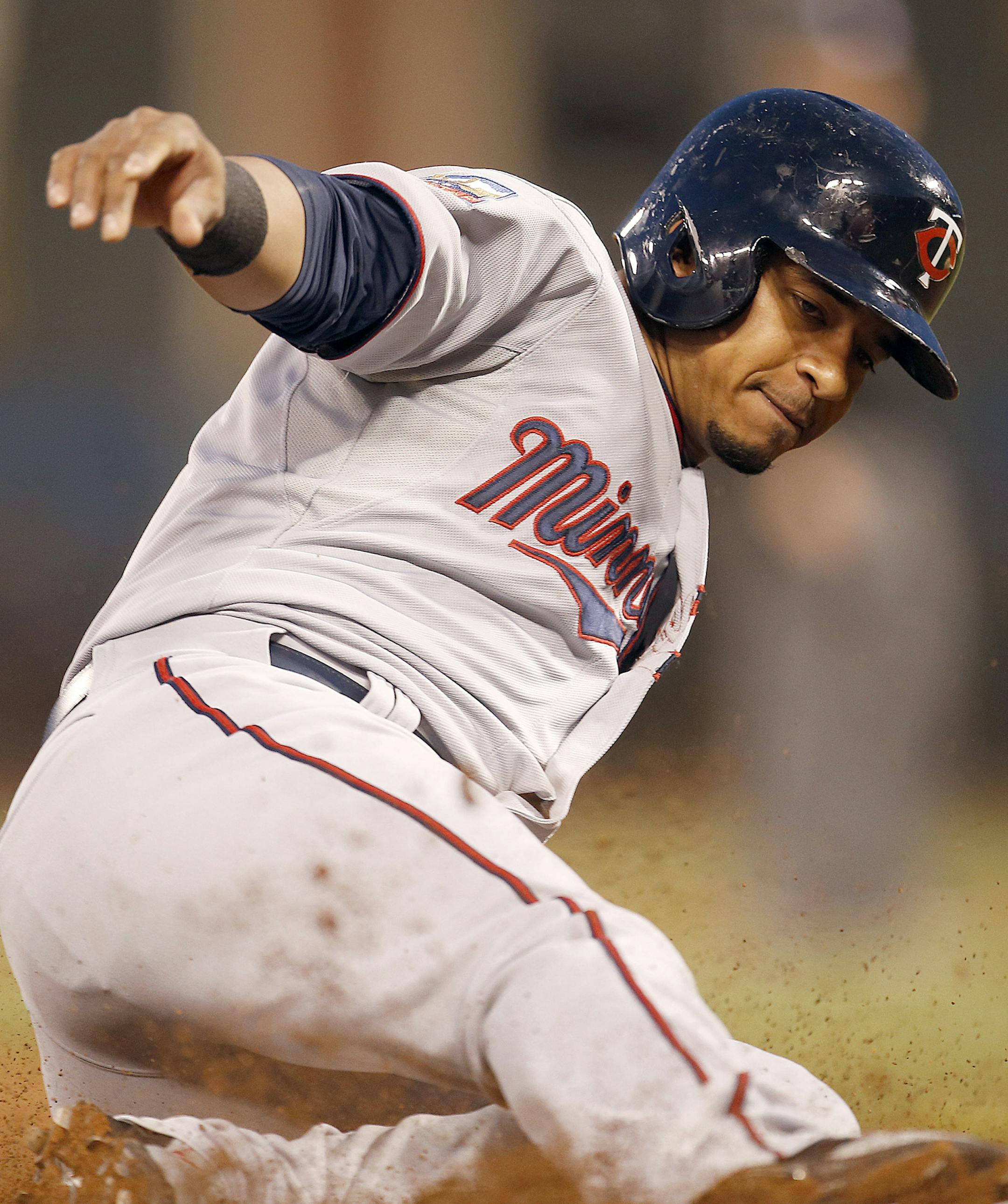 Minnesota Twins' Eduardo Escobar slides into third base on a wild pitch by San Francisco Giants starting pitcher Tim Lincecum in the third inning of a baseball game Friday, May 23, 2014, in San Francisco. (AP Photo/Tony Avelar)
