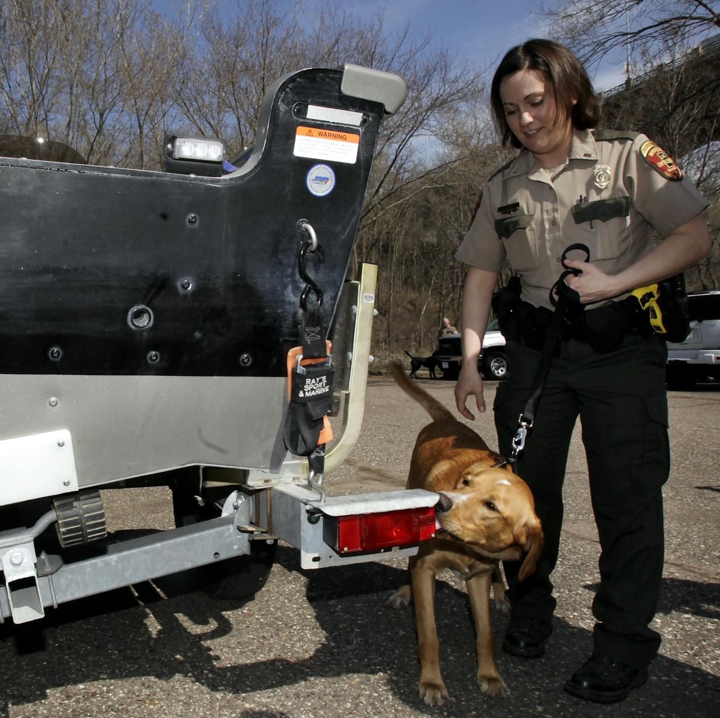 Julie Siems, a Conservation Officer for The Minnesota Department of Natural Resources, took her K-9 mussel-sniffing dog Brady around a boat to find zebra mussels that Conservation Officer Travis Muyers hid in the tail light of a boat at the Fort Snelling State Park. Less than a minute after, Brady sniffed out the zebra mussels in the tail light of the trailer. St. Paul, MN on May 7, 2013. ] JOELKOYAMA&#x201a;&#xc4;&#xa2;joel koyama@startribune.com The Minnesota Department of Natural Resources wi