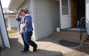 Emily Burleson ferries items from a moving pod to the house she recently bought with her husband Carl Yederlinic after moving from Tampa, Fla., to Wes
