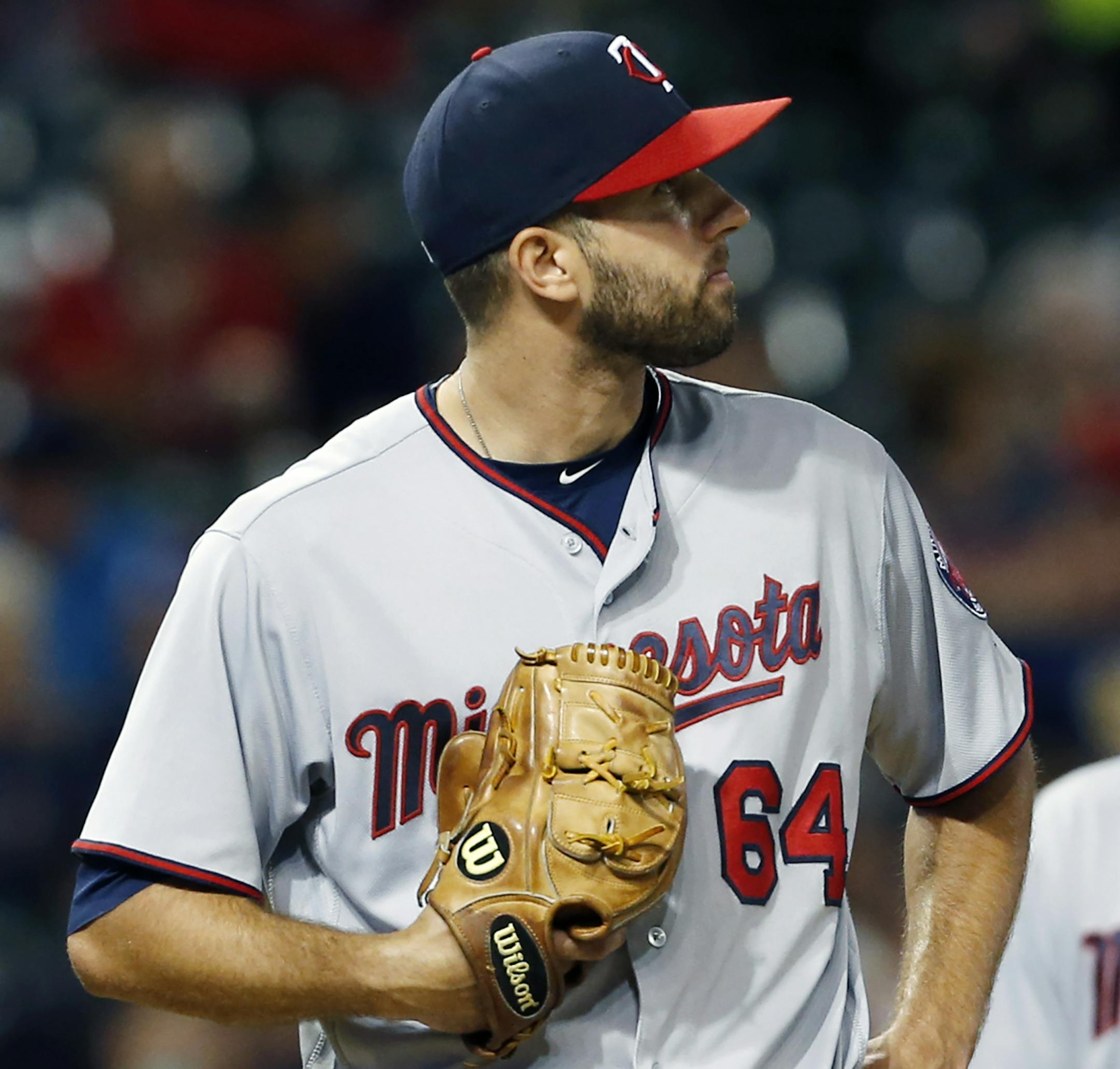 Minnesota Twins starting pitcher Pat Dean reacts after walking Cleveland Indians' Mike Napoli to load the bases during the fifth inning of a baseball game Wednesday, Aug. 31, 2016, in Cleveland. (AP Photo/Ron Schwane)