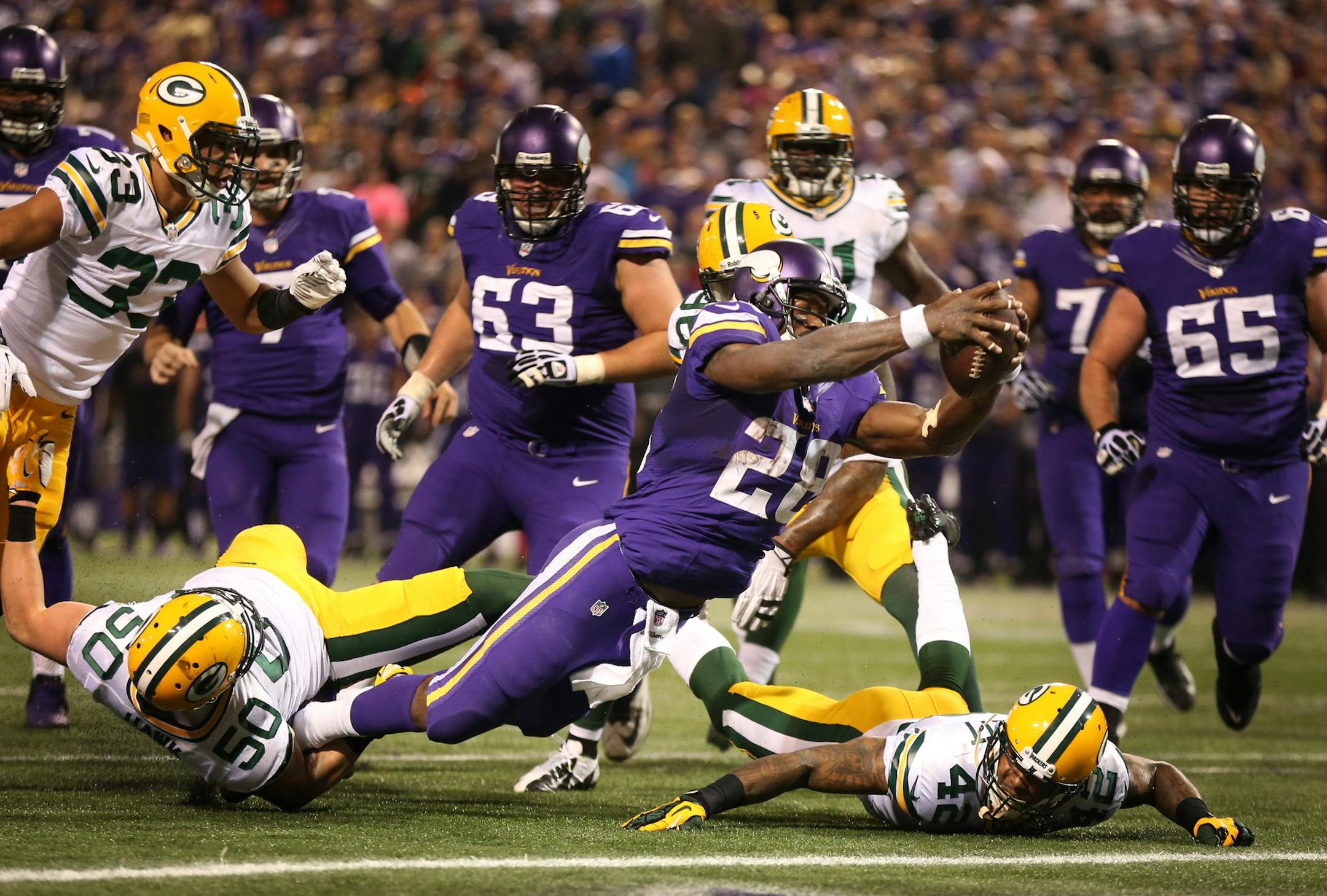 Vikings running back Adrian Peterson dove for an 8-yard touchdown in the second quarter. ] MCKENNA EWEN · mckenna.ewen@startribune.com Minnesota Vikings and Green Bay Packers - Mall of America Field in Minneapolis, Minnesota - 10/21/2013