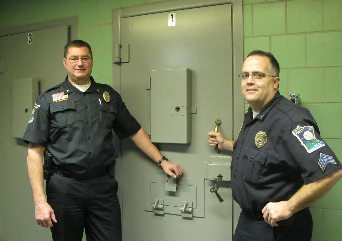 Police Chief Rick Peterson, left, and Capt. Greg Weiss (then a sergeant) were shown at the holding cells of the city's old police department in 2011.