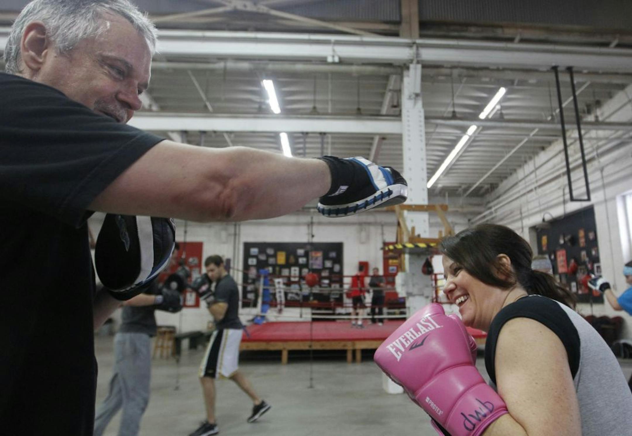 At Upper Cut Boxing Gym in northeast Minneapolis, couple Peter Baker and wife Debbie Ward-Baker took turns taking a whack at each other on a Saturday morning training day.