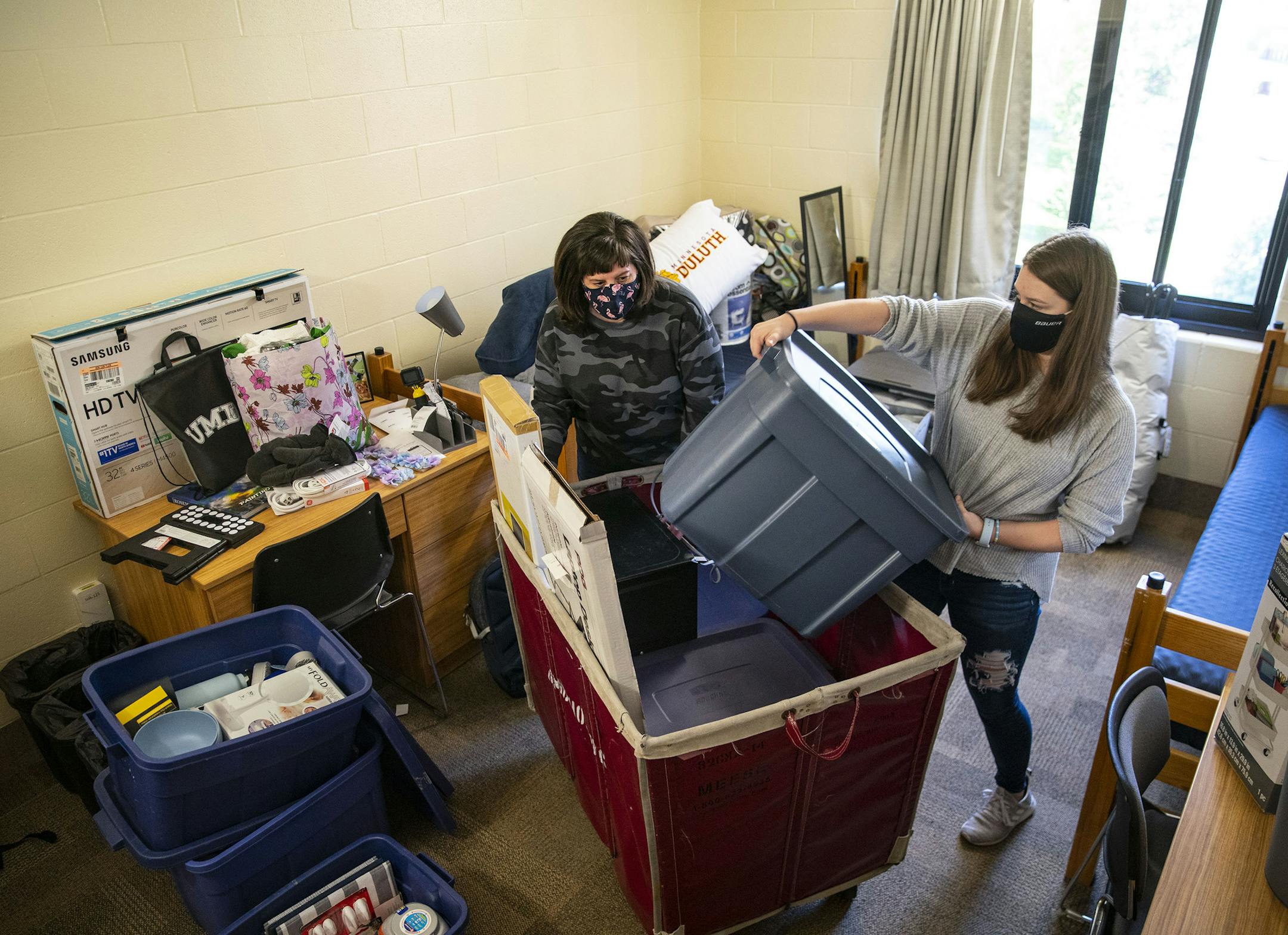 Riley Krenz, an freshman Chemistry major from Rosemount, MN, and her mother, Molly, began unpacking the second of three carts with her belongings as they moved Riley into her room in Ianni Hall at UMD on Thursday. ] ALEX KORMANN • alex.kormann@startribune.com The University of Minnesota Duluth spread out it's normally one day move-in bonanza over three days. Each student was given a specific move-in time to try and stagger the amount of people in the residence halls.