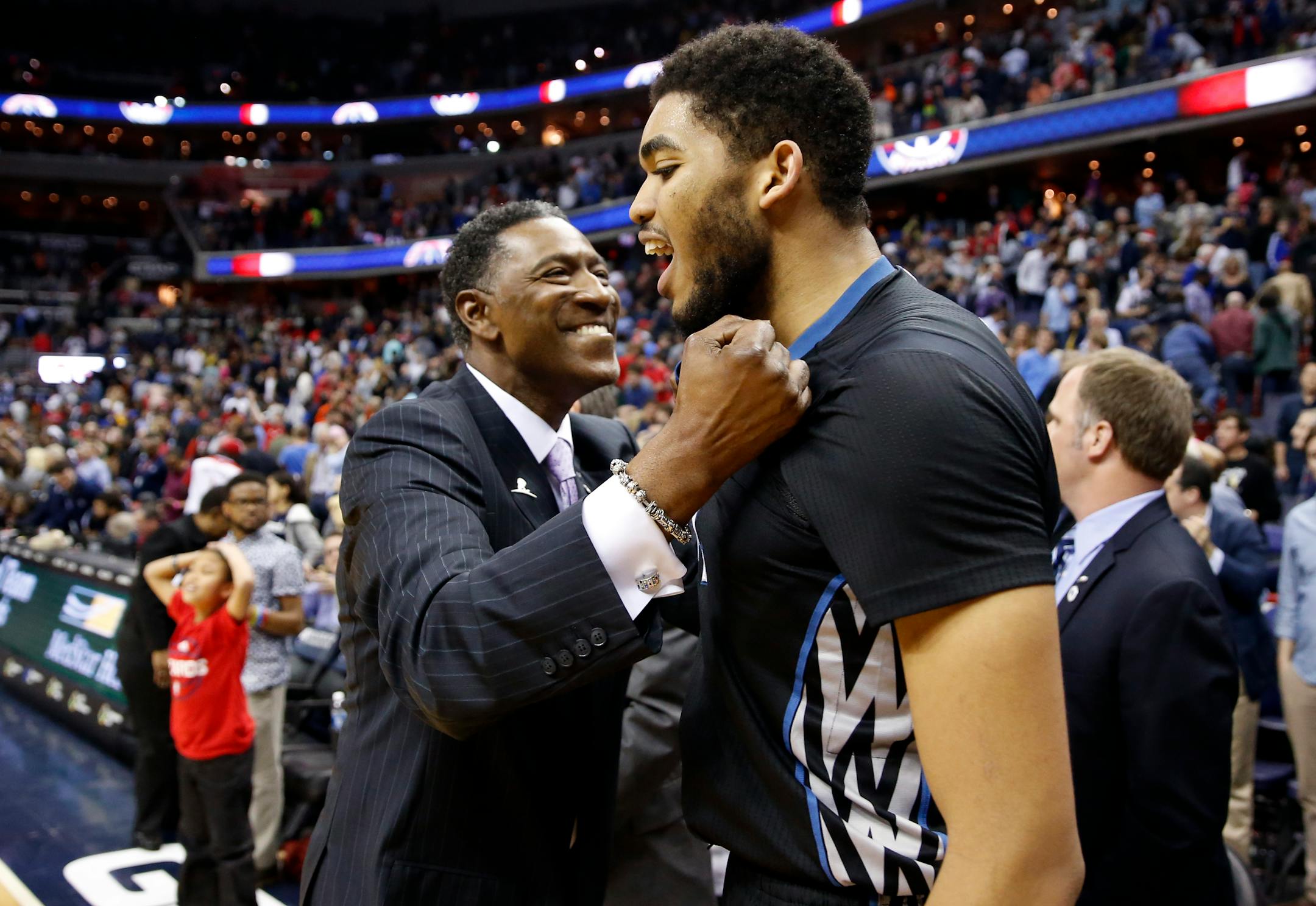 Minnesota Timberwolves coach Sam Mitchell celebrates with center Karl-Anthony Towns after the team's game against the Washington Wizards, Friday, March 25, 2016, in Washington. The Timberwolves won 132-129 in double overtime.
