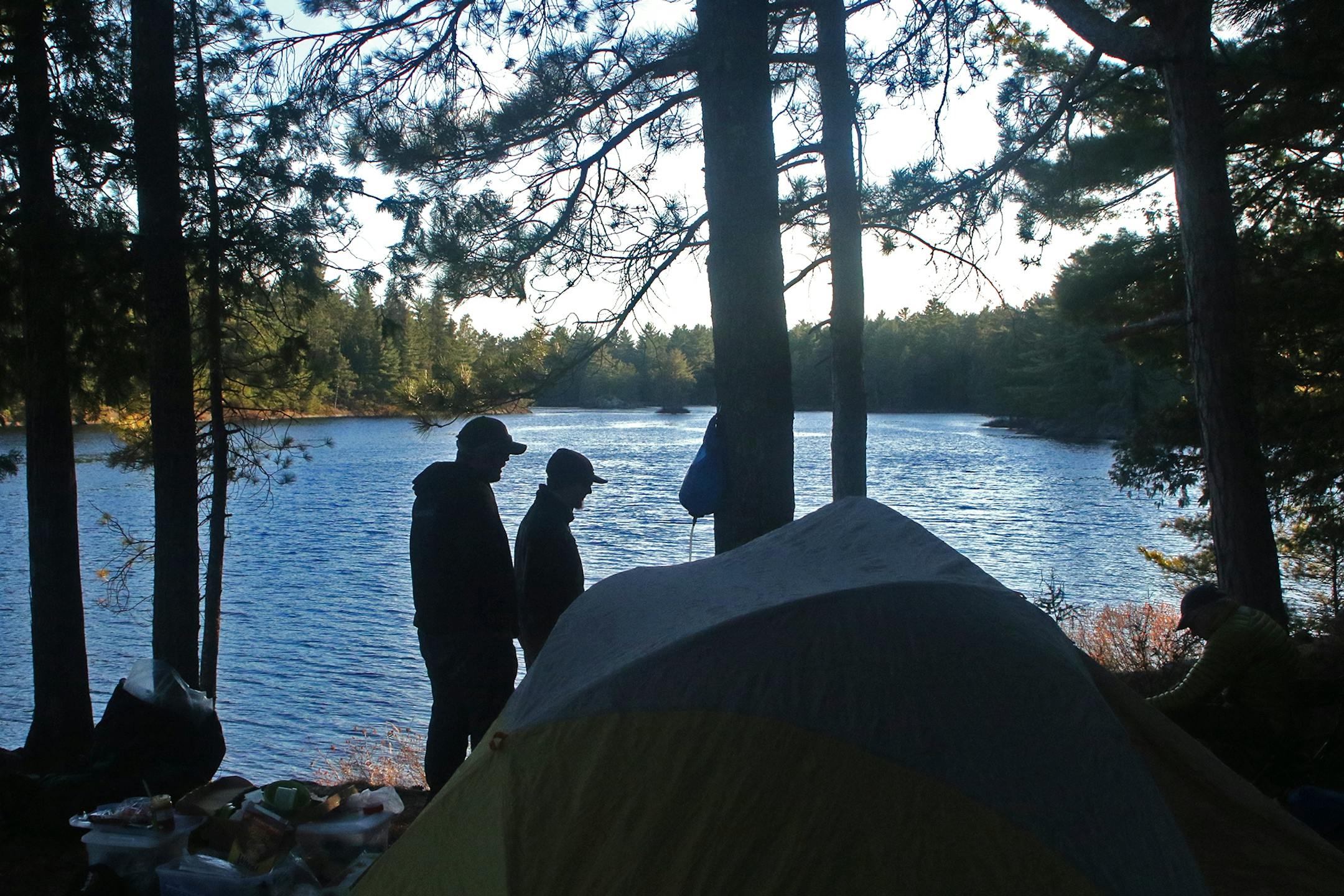 Aaron Youngblom, left, and Carson Spohn, both of Duluth, at their campsite in Quetico Provincial Park on a first-of-the-season lake trout fishing trip.
