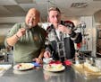 Chef Yia Vang tries lutefisk with Nels Thompson, who shared the Scandinavian tradition at Bethlehem Lutheran Church in Minneapolis.