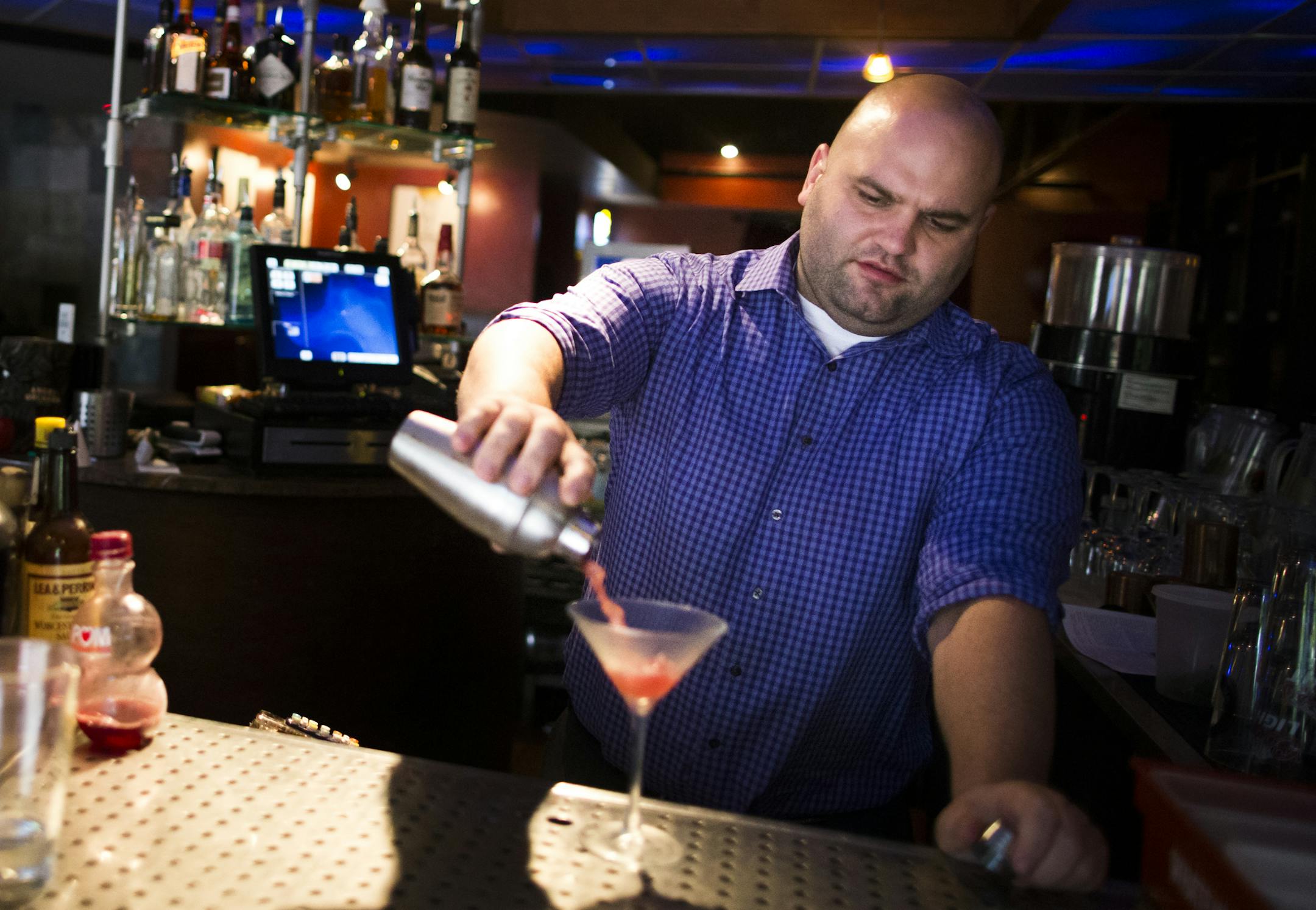Manager Phil Werner mixed a drink at Shanghai Bistro in Stillwater, MN on September 5, 2014, in Stillwater, Minn. Werner finds most the Shanghai Bistro employees prefer to work at the Stillwater location rather than the Hudson, Wis. Shanghai Bistro because the minimum wage is higher and the menu prices are higher which equals more tips. ] RENEE JONES SCHNEIDER • reneejones@startribune.com
