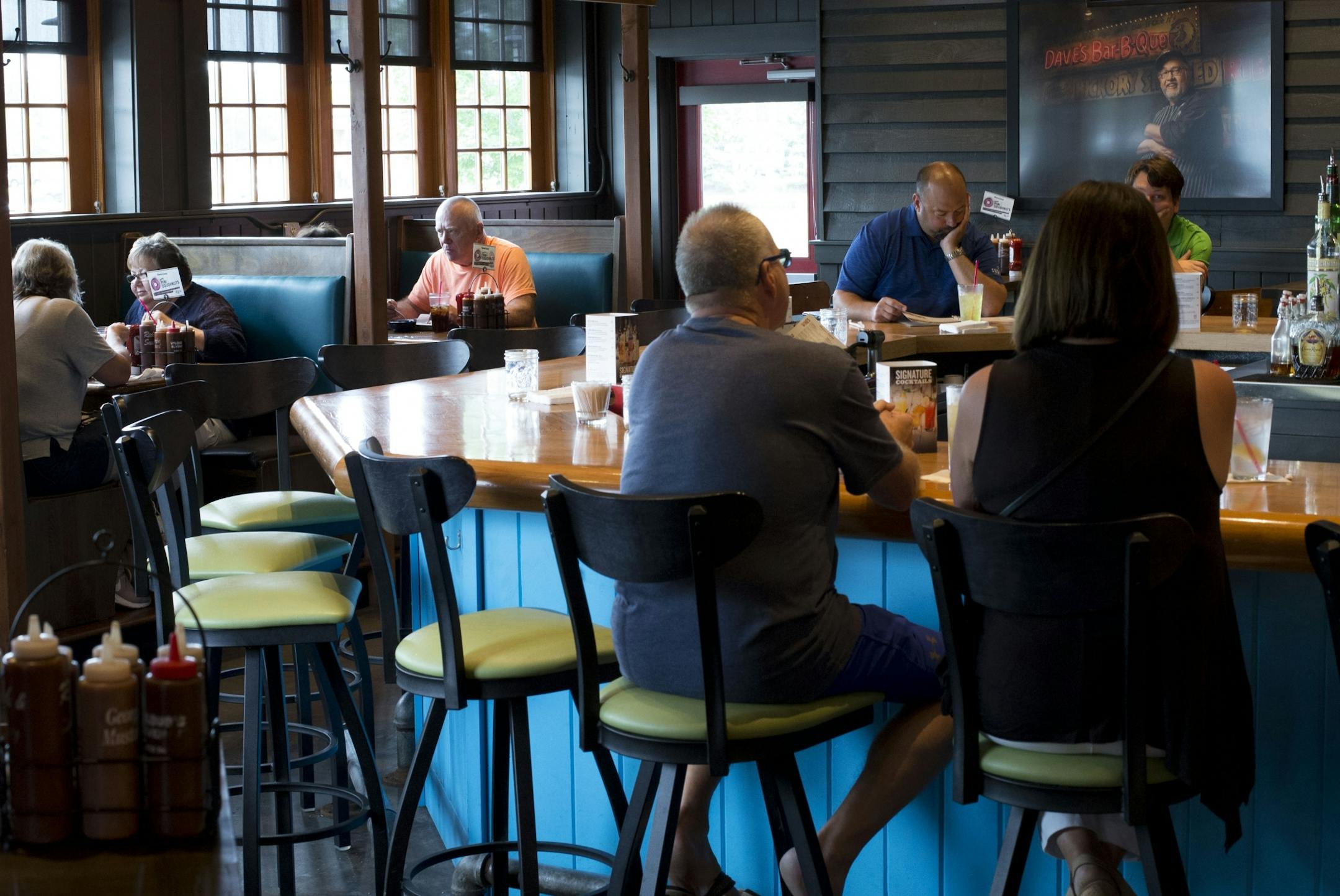 Lunch patrons sit in the bar area of Famous Dave's in Coon Rapids to enjoy a meal off their new menu.