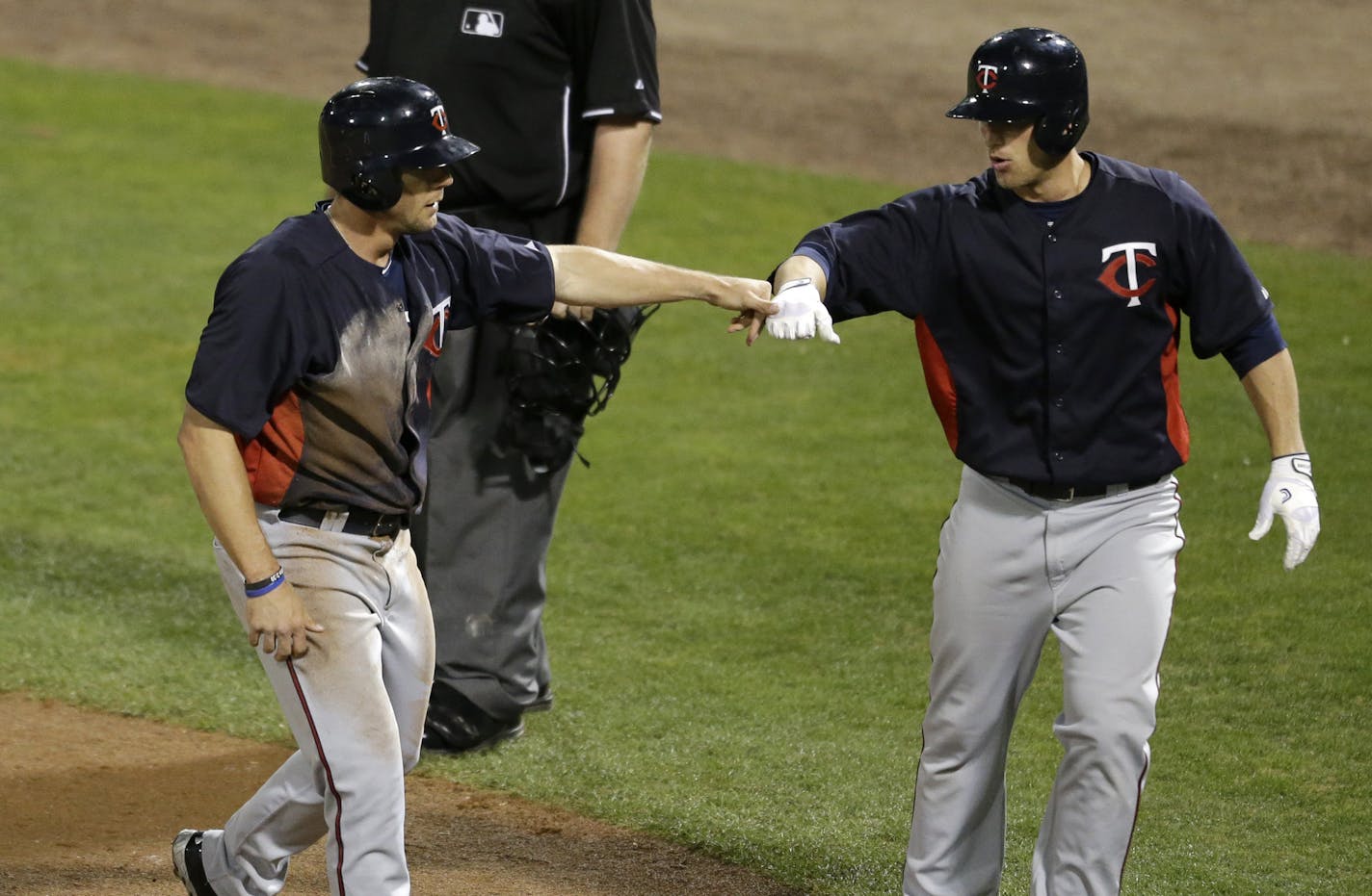 Twins center fielder Clete Thomas, left, scored the go-ahead run against the Rays off a triple by Ray Olmedo in the 10th inning Monday night. Thomas led off the inning with a double.