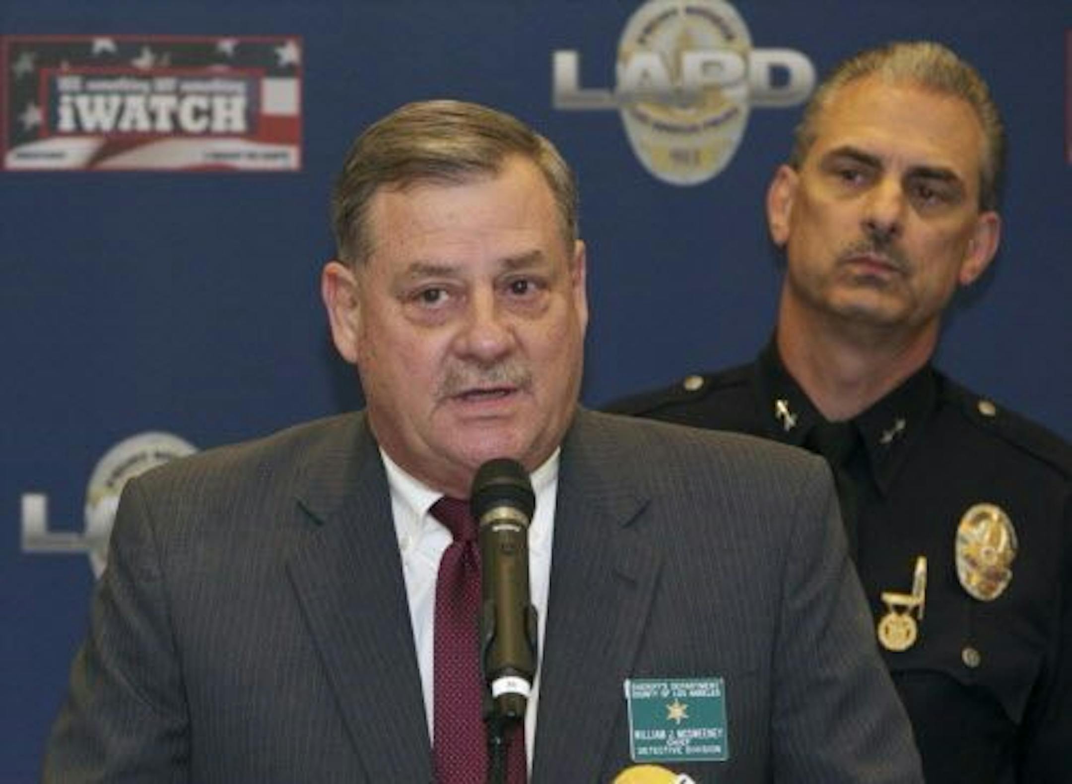 Bill McSweeney, Los Angeles County Sheriff's Department Chief Detective Division, left, with Los Angeles Police Department Deputy Chief Kirk Albanese, takes questions from the media during a news conference in Los Angeles, Tuesday, Aug. 26, 2014.