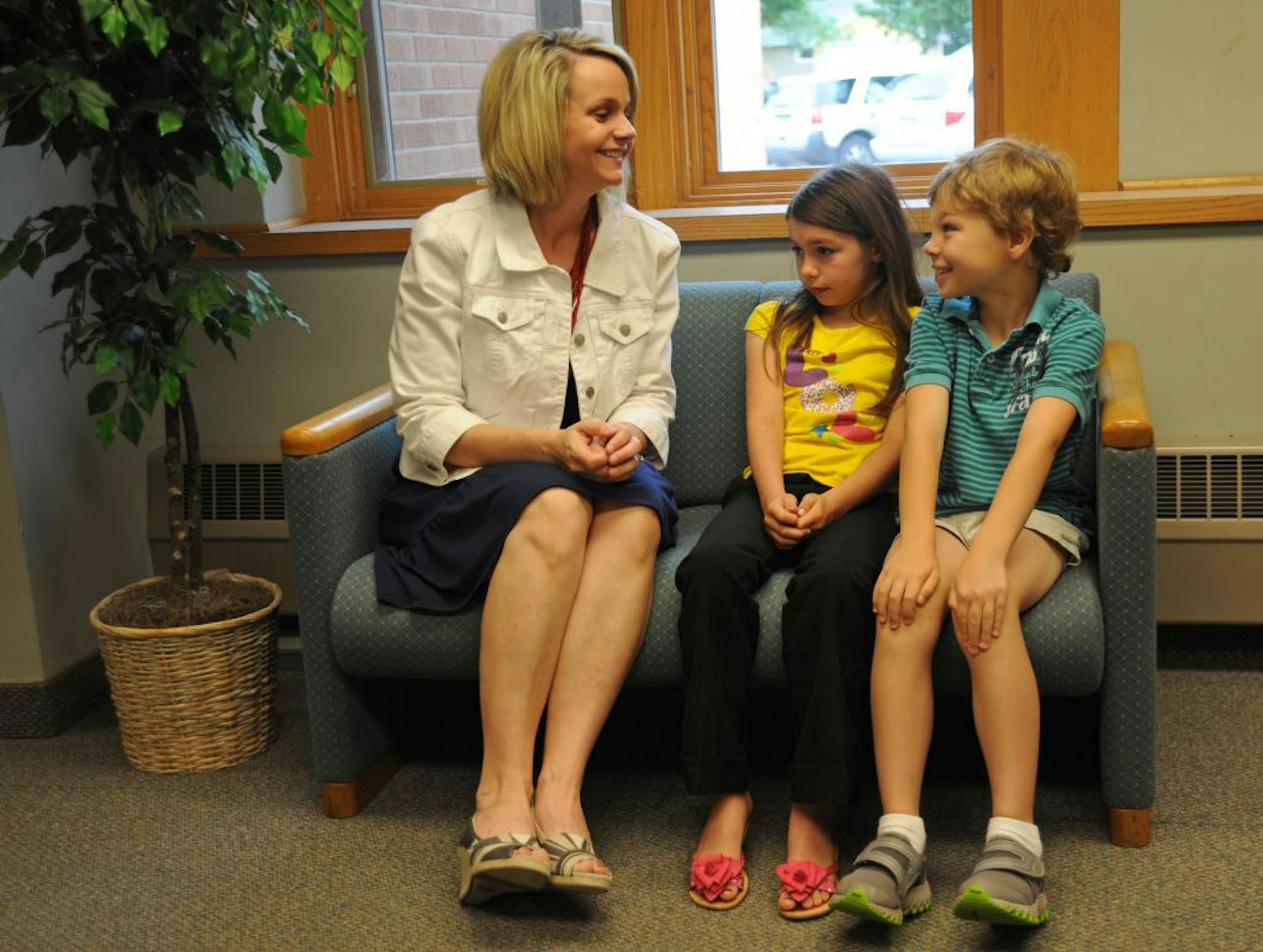 One of the tactics used at Farmington Elementary to improve student performance is "staff buddies," where staff members are "buddies" with students, giving those students an additional "positive adult contact." Increasing the number of these positive adult contacts has been shown to help children do better in school. Angela Nguyen is an ELL teacher and was visiting on this hallway couch with 2 of her buddies, Juliana Salisbury and Quincy Aaron who are both second graders at Farmington Elementary
