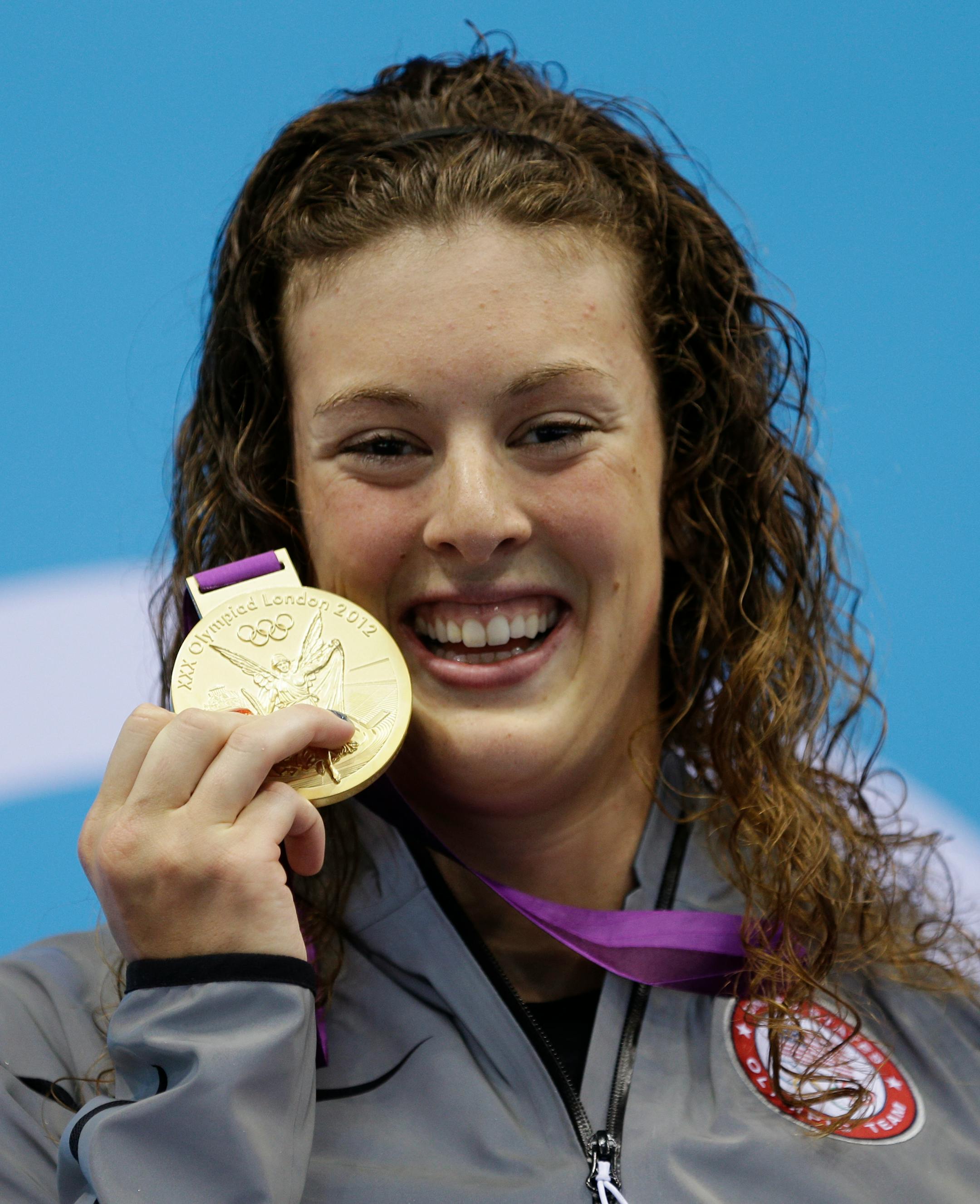 The United States' Allison Schmitt proudly displayed her gold medal after winning the women's 200-meter freestyle on Tuesday in London.