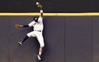 Brewers outfielder Keon Broxton made a leaping catch on a ball hit by Twins second baseman Brian Dozier on July 4, 2018 in Milwaukee.