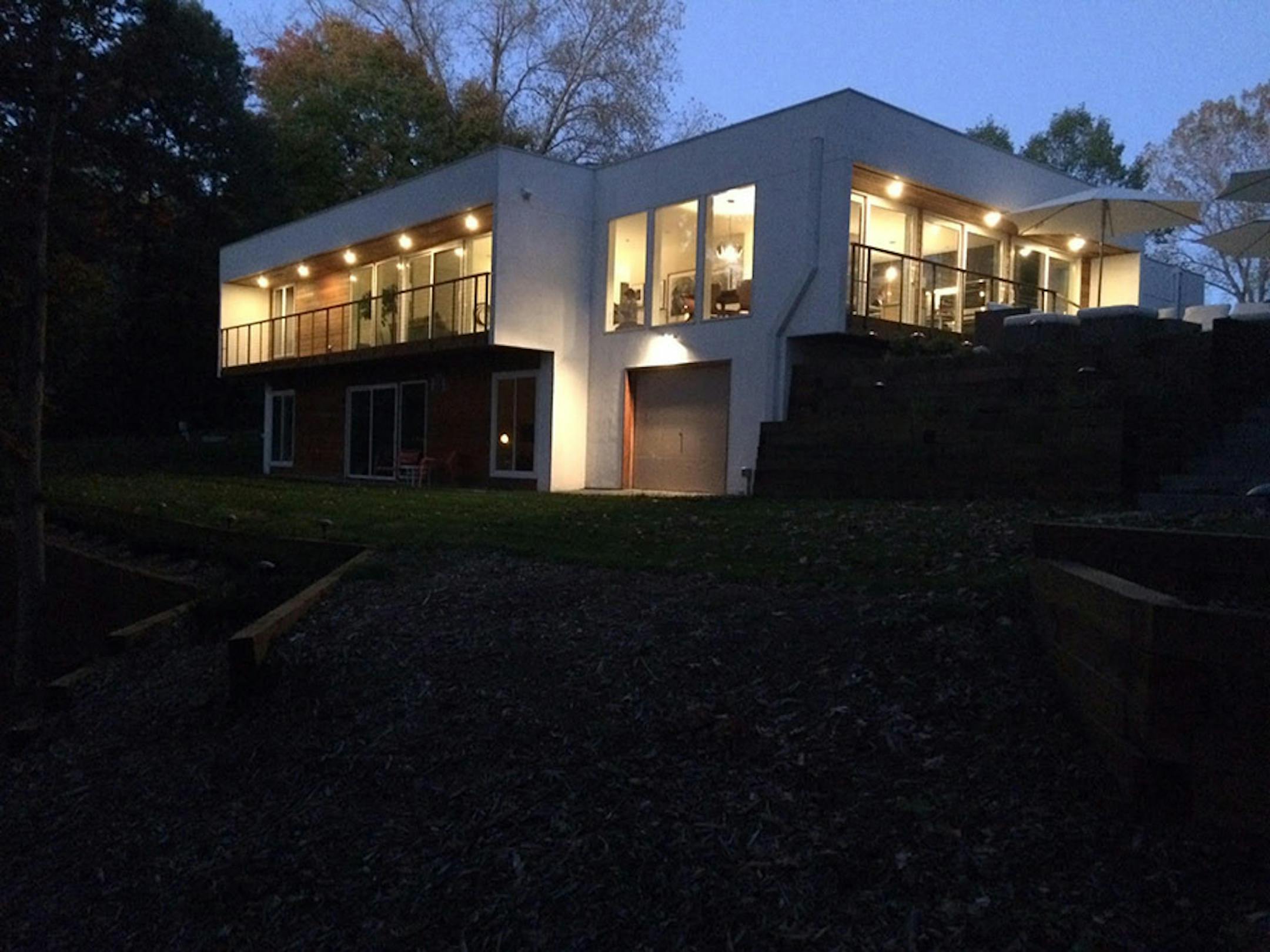 The rear of the home with a walk-out level and pond views.