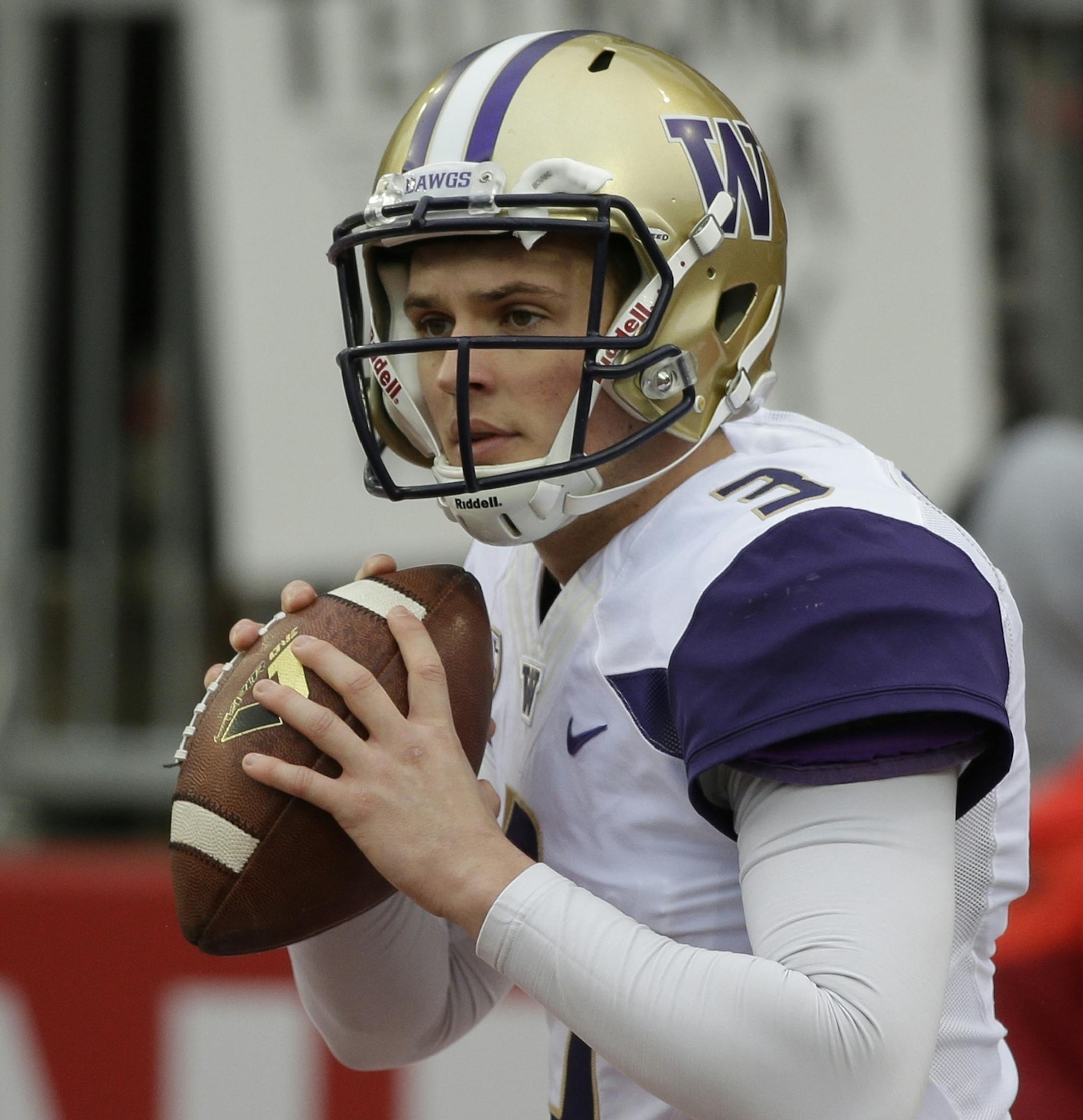 FILE - In this Nov. 25, 2016, file photo, Washington quarterback Jake Browning warms up before an NCAA college football game against Washington State, in Pullman, Wash. The fourth-ranked Huskies take on Colorado in the Pac-12 championship on Friday night in Santa Clara, Calif. Both teams rely heavily on their quarterbacks. (AP Photo/Ted S. Warren, File)