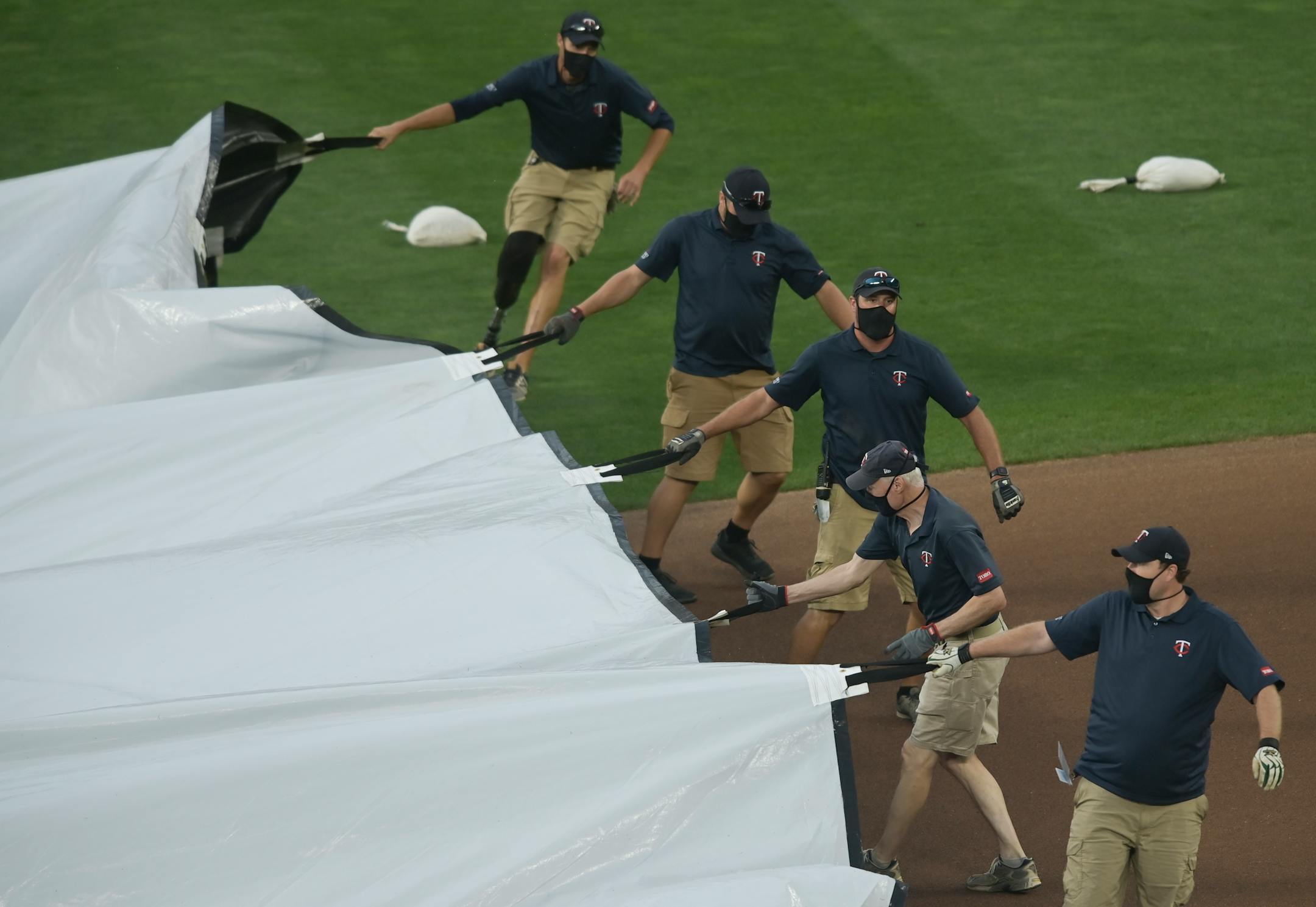 The Minnesota Twins grounds crew pulled the tarp onto the field before Friday night's game postponement was announced. ] aaron.lavinsky@startribune.com The Minnesota Twins played the Kansas City Royals on Friday, Aug. 14, 2020 at Target Field in Minneapolis, Minn.
