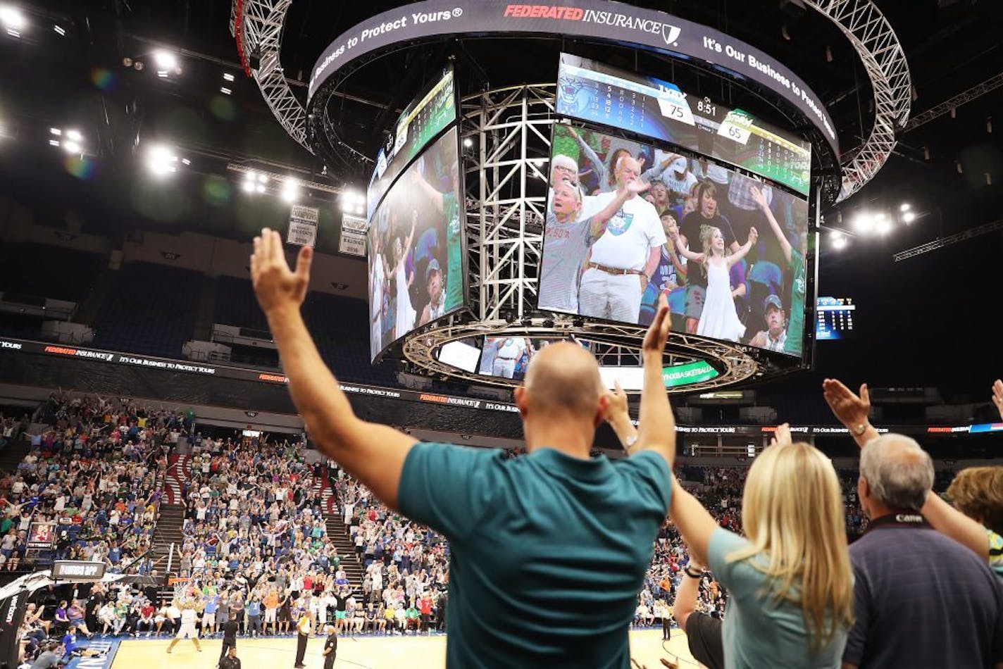 The new scoreboard is seen as fans dance during the second half.