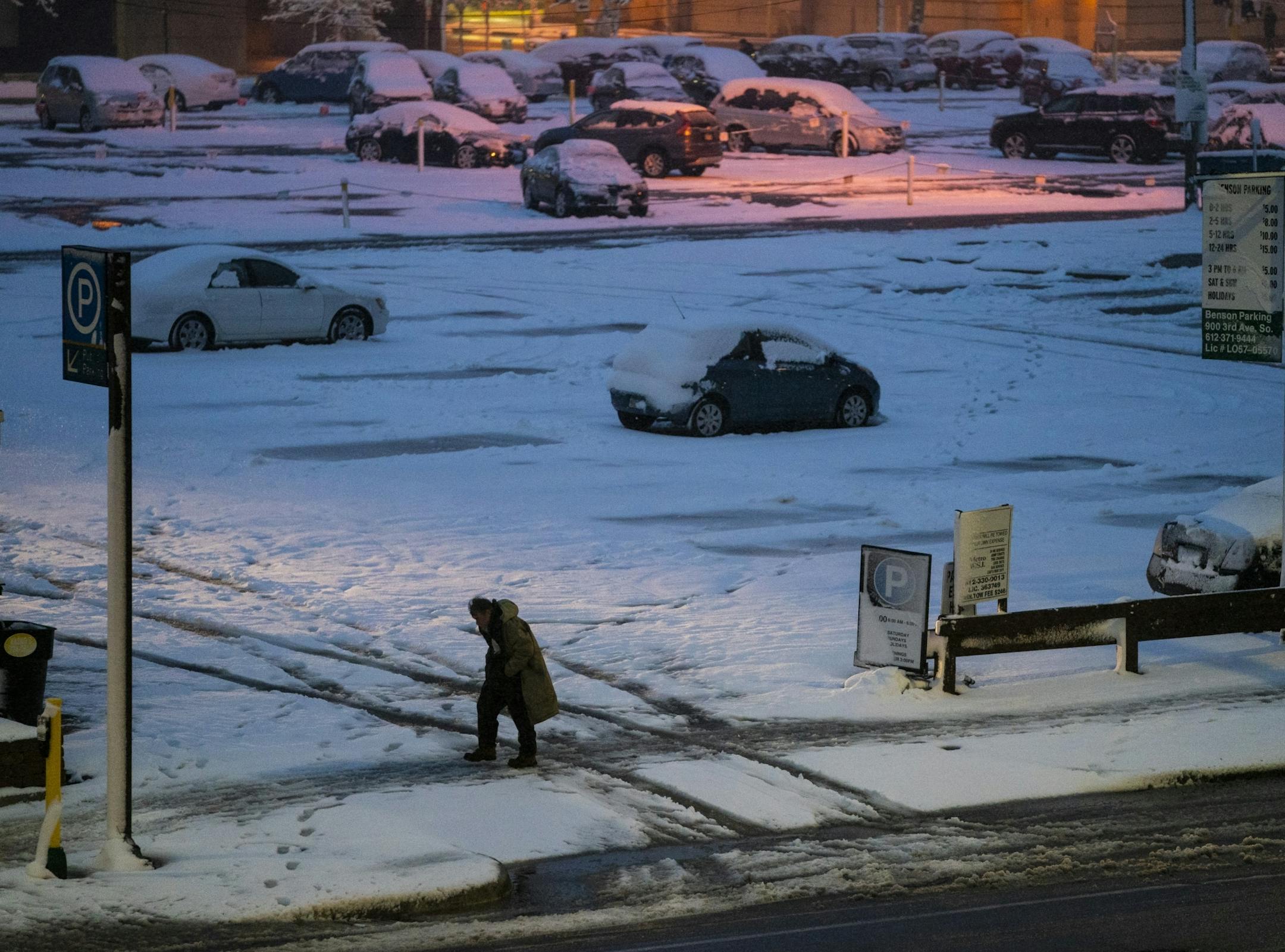 A man walked through a snowy downtown Minneapolis on Wednesday night.