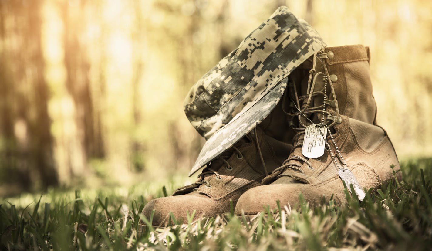 iStock
USA military boots, hat and dog tags in outdoor yard. No people in this Memorial Day or Veteran's Day image.