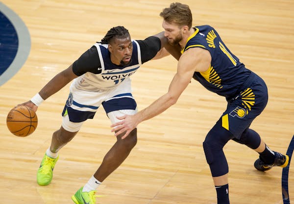 The Wolves' Naz Reid was defended by Domantas Sabonis of the Pacers on Wednesday.