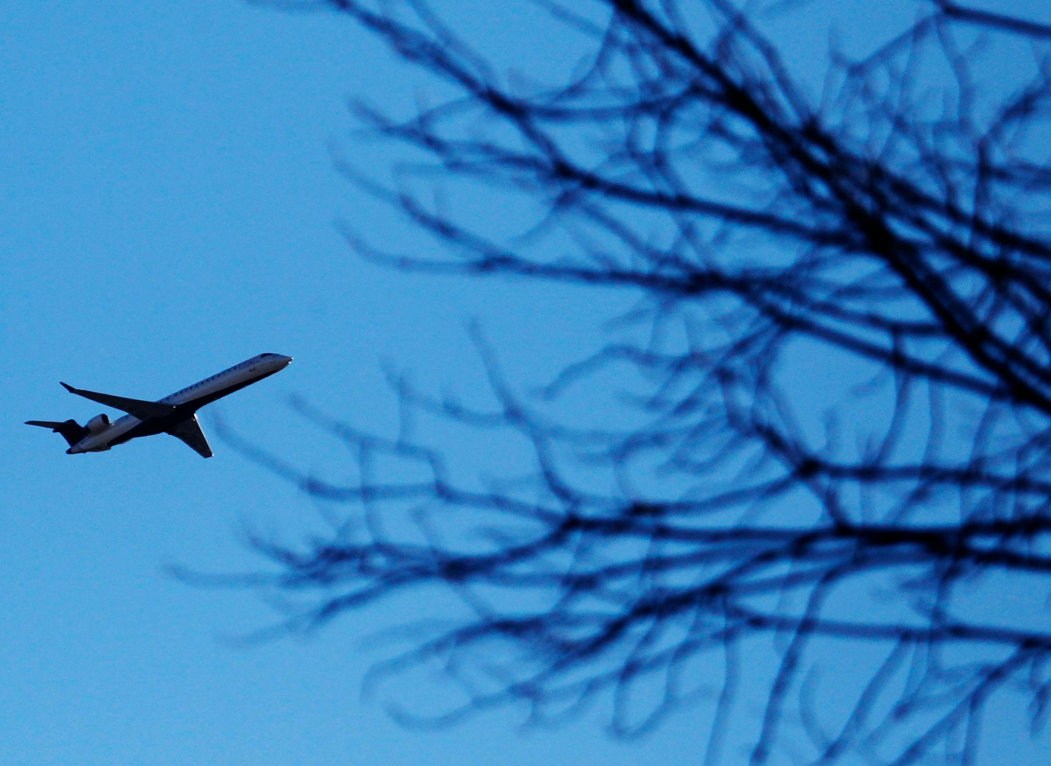 In this file photo, a plane that took off from Minneapolis-St. Paul Airport cruises over a southwest Minneapolis.